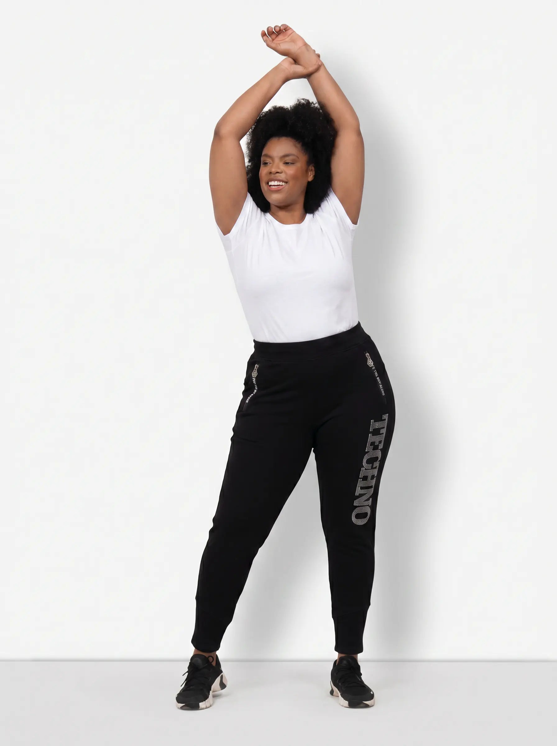 Person wearing a white top and black pants with 'INCERNE' branding on a white background, TCH TECHNO Rhinestone Jogger Pants