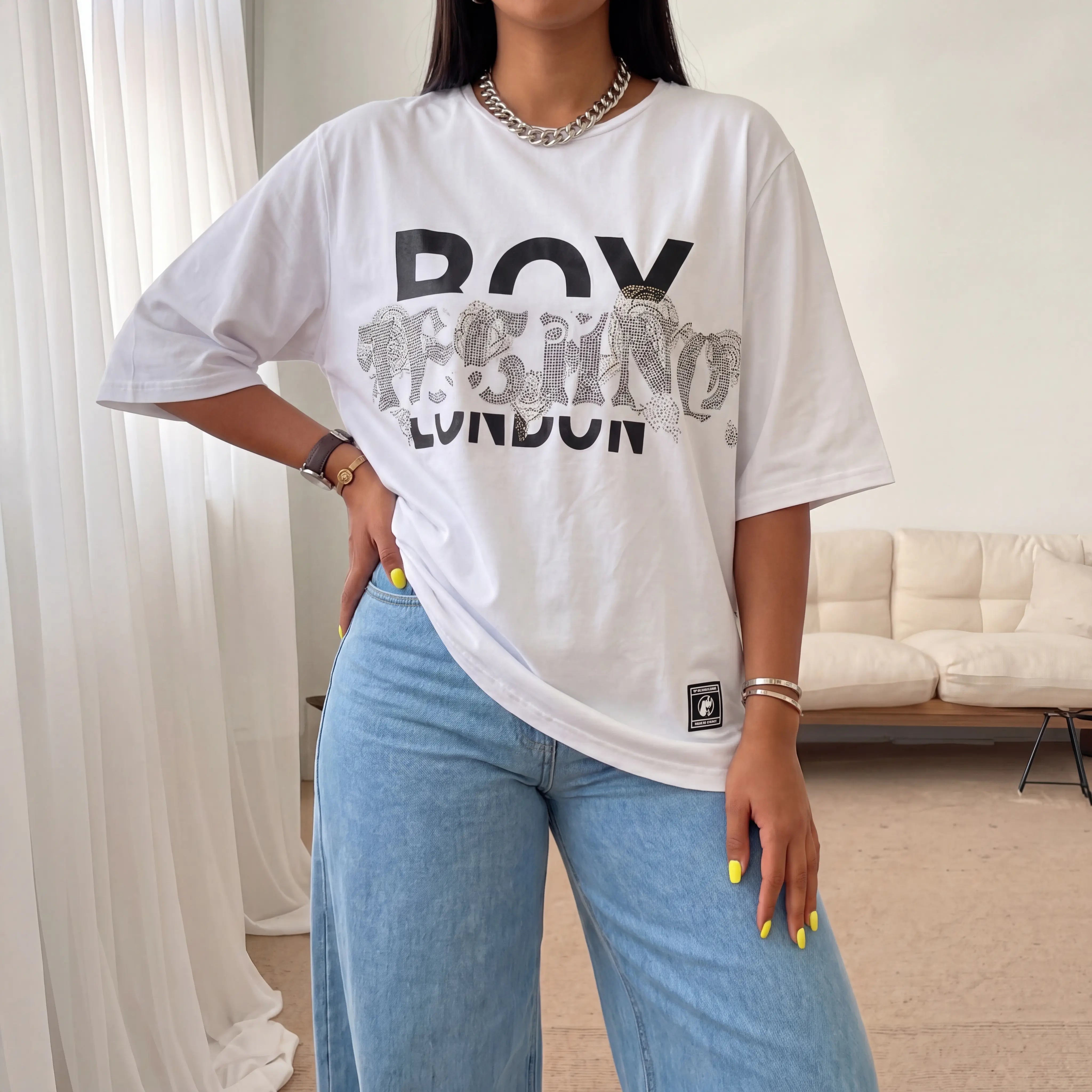 Person wearing a white t-shirt with text and blue jeans in a room. TCH TECHNO Rhinestone Layered Typography T-Shirt