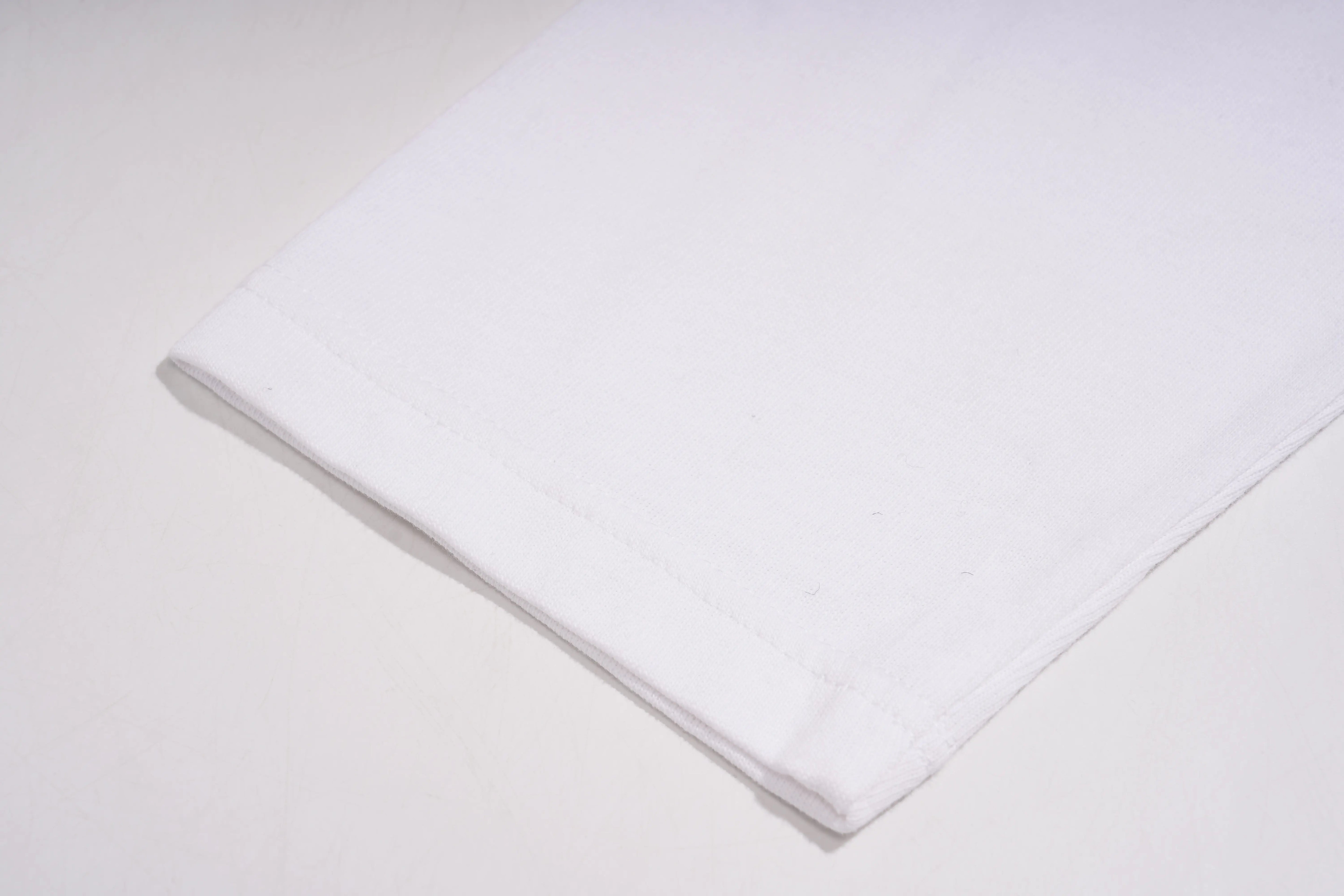 Folded white towel on a light gray background, TCH TECHNO Rhinestone Layered Typography T-Shirt