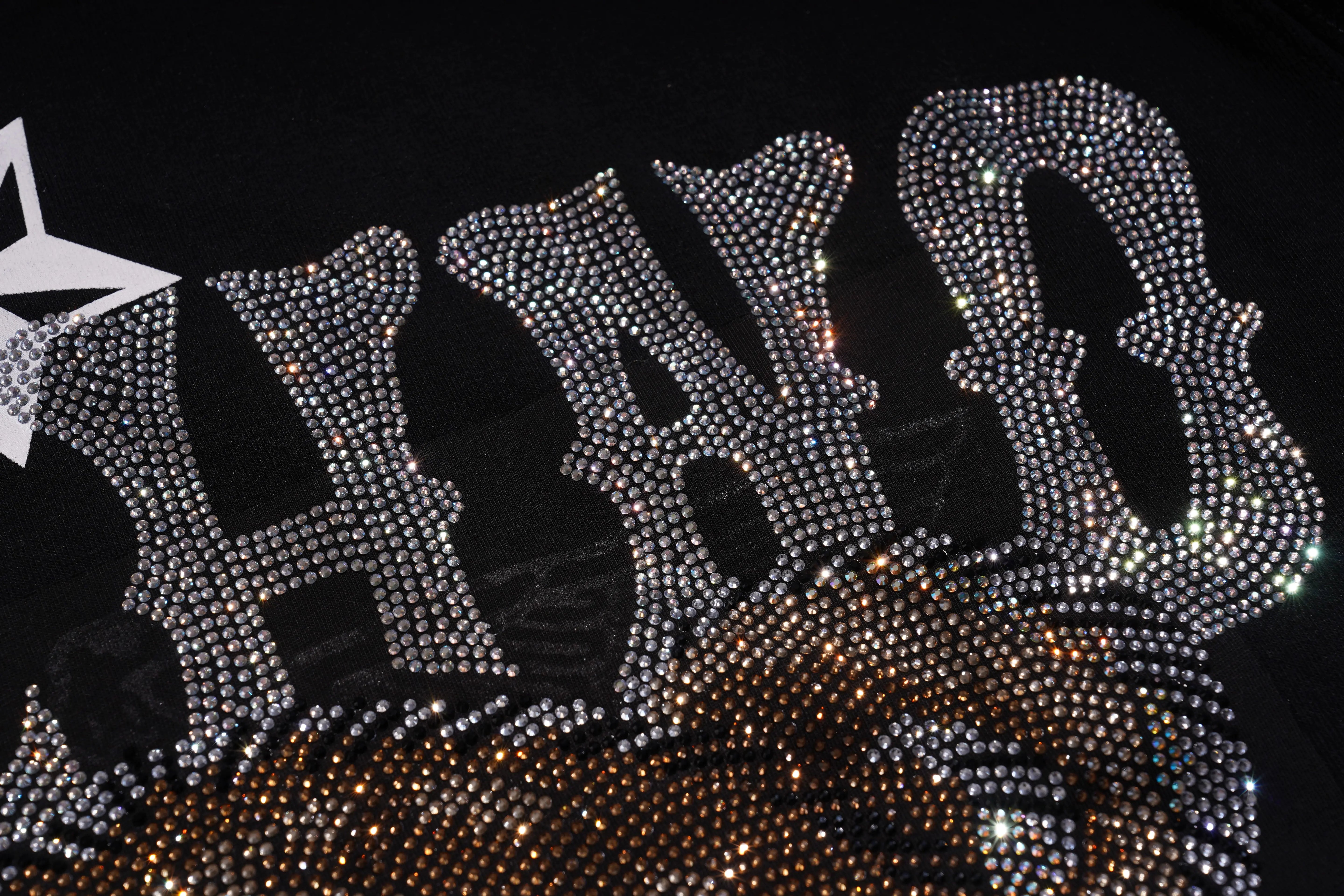 Decorative headband with rhinestone embellishments on a black background, TCH TECHNO Rhinestone Teddy Sweatshirt