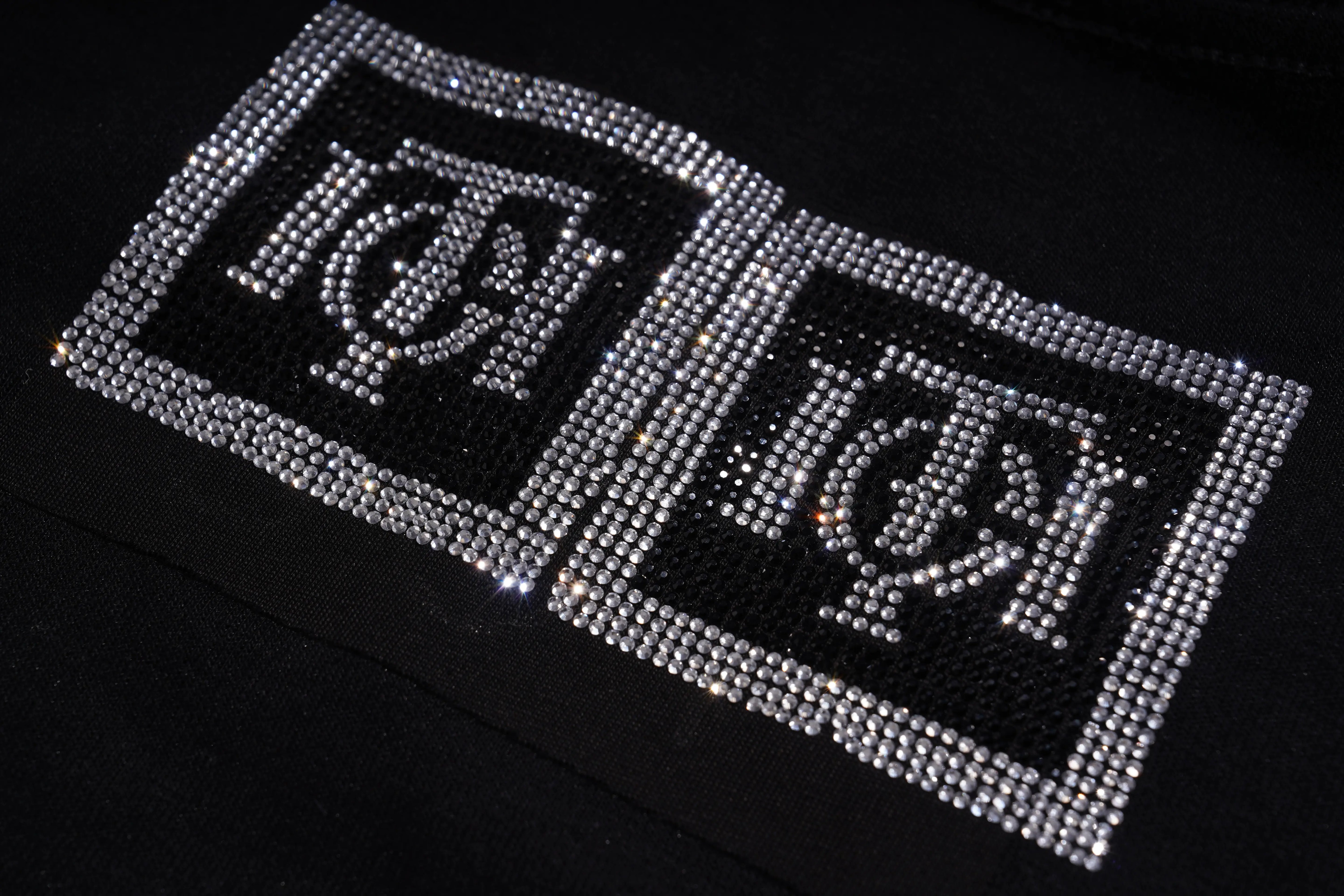 Two rhinestone patches with a symbol on a black background, TCH TECHNO Rhinestone Teddy Sweatshirt