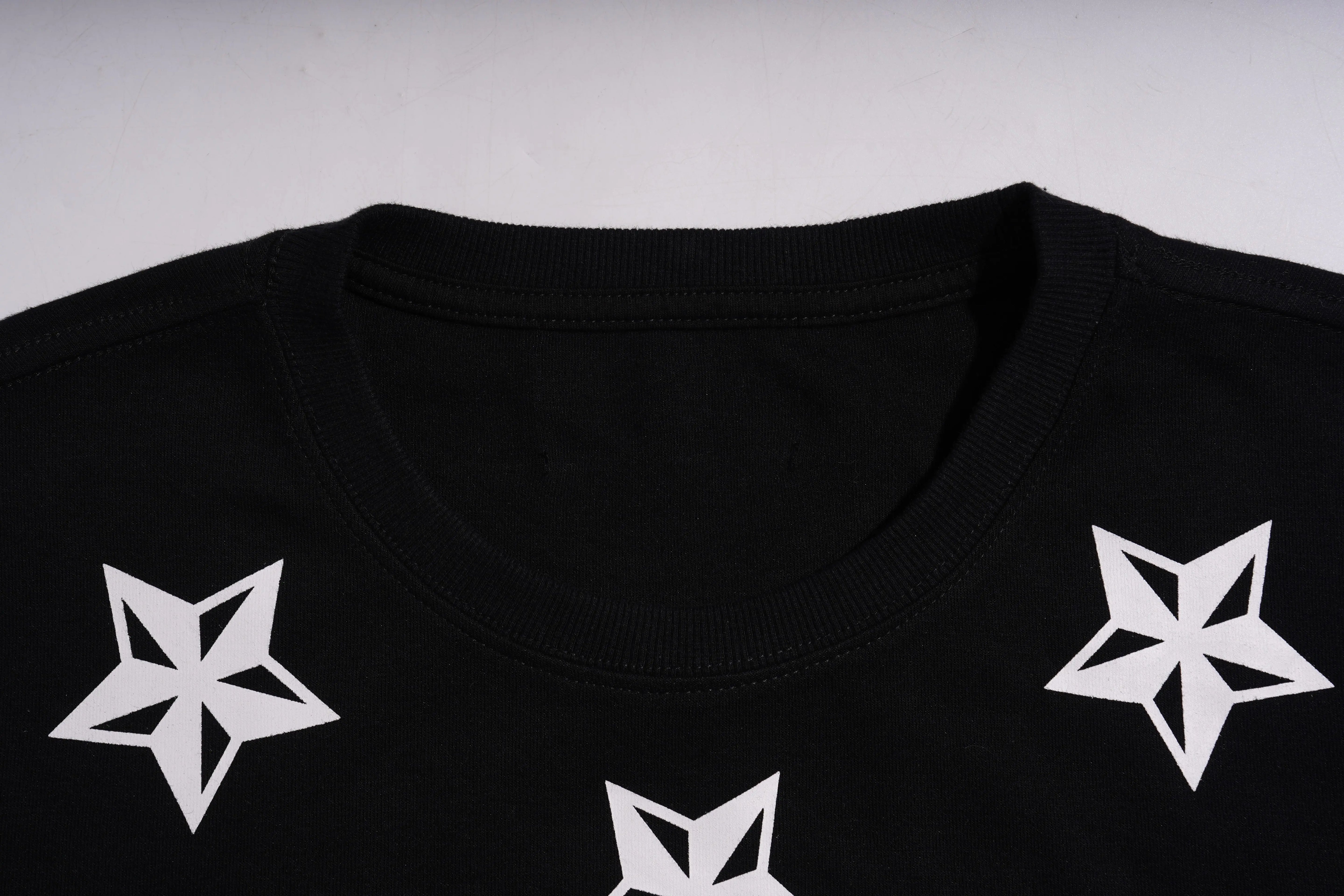 Black shirt with white star patterns on a plain background, TCH TECHNO Rhinestone Teddy Sweatshirt