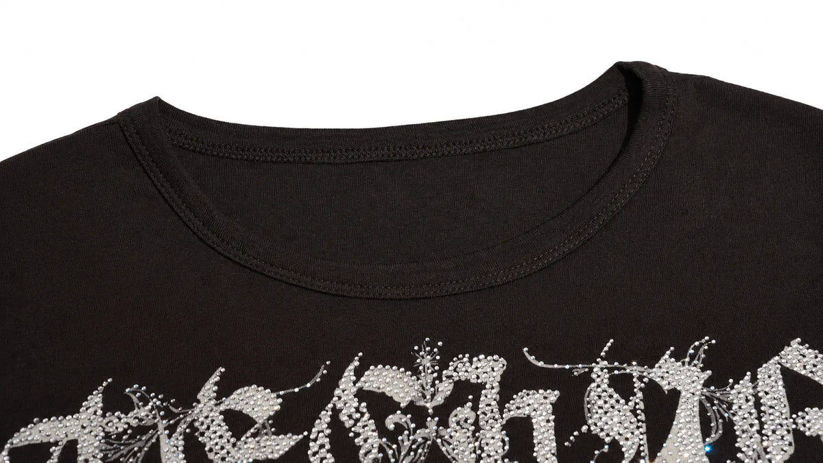 Close-up of a black crewneck t-shirt featuring a silver rhinestone graphic across the chest, set against a plain white background. TCH Techno Butterfly Starburst Graphic Long Sleeve Top