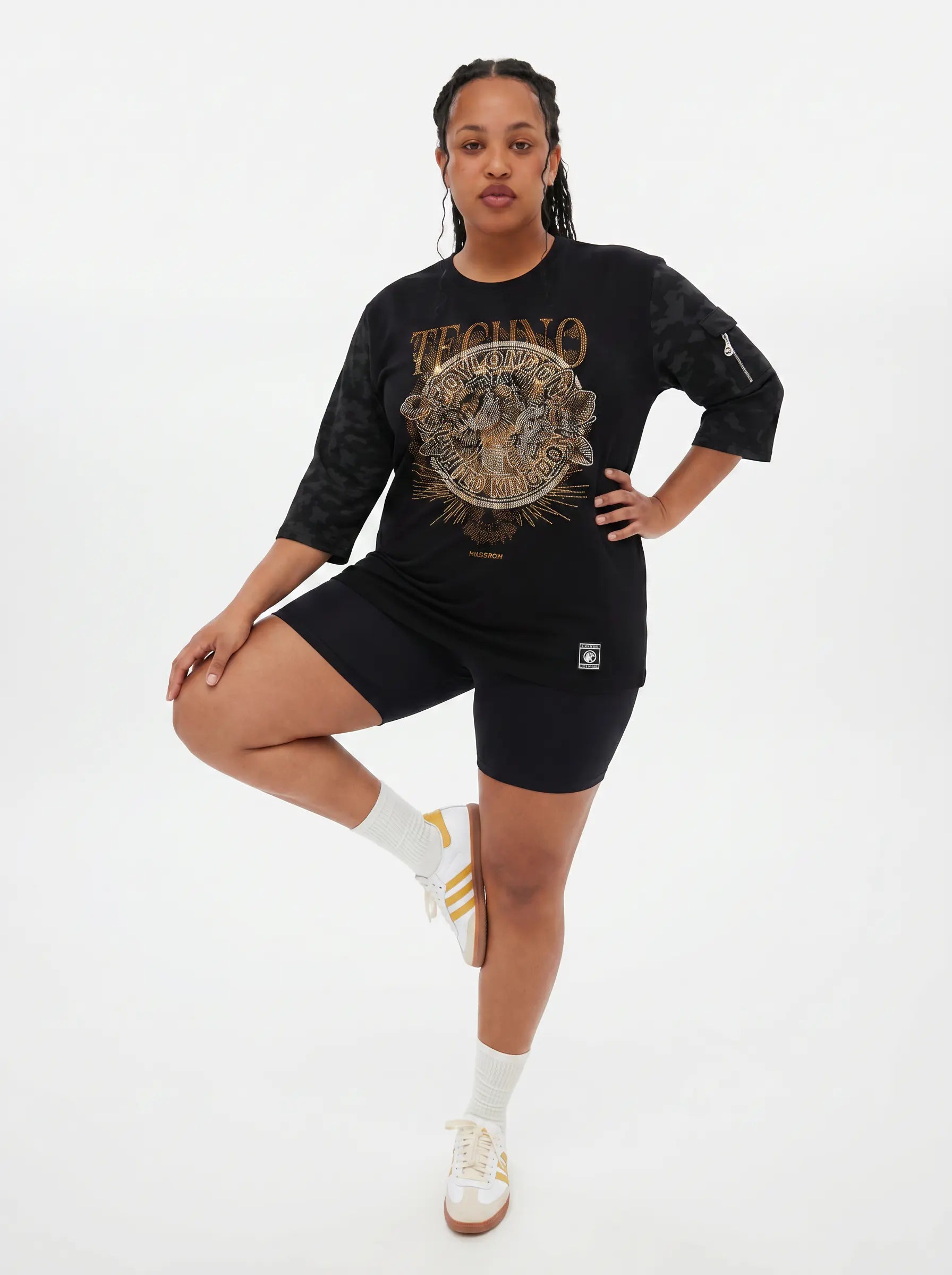 Person wearing a black graphic t-shirt and black shorts on a white background, TCH Techno Rhinestone Graphic Oversize T-Shirt