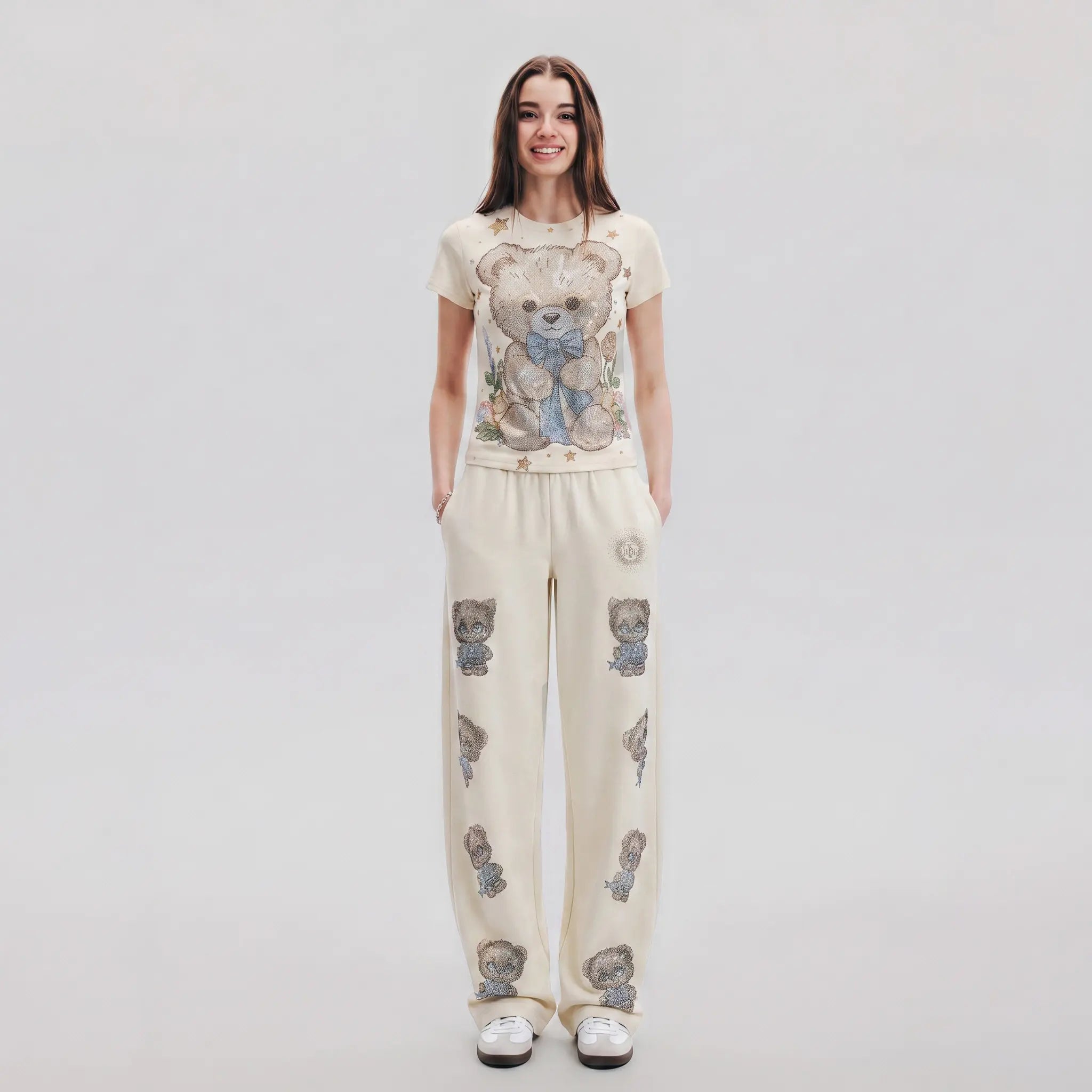 Woman wearing a t-shirt and pants with teddy bear patterns on a plain background, TCH Teddy Bear Garden Rhinestone Lounge Set