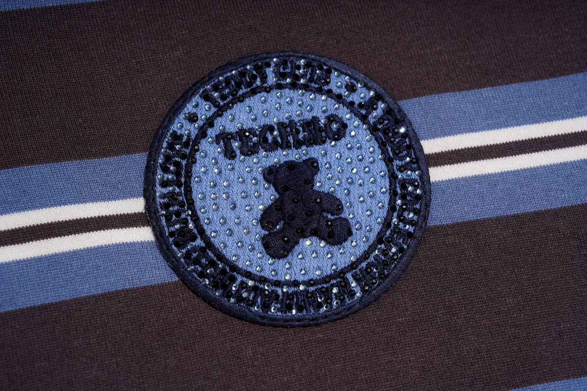 A circular embroidered patch featuring a teddy bear and the text 'TECHIMO' and 'WORLD'S MOST FUN JUMPMAN', placed on a brown and blue striped knit garment. TCH Women's Striped Polo Mini Dress