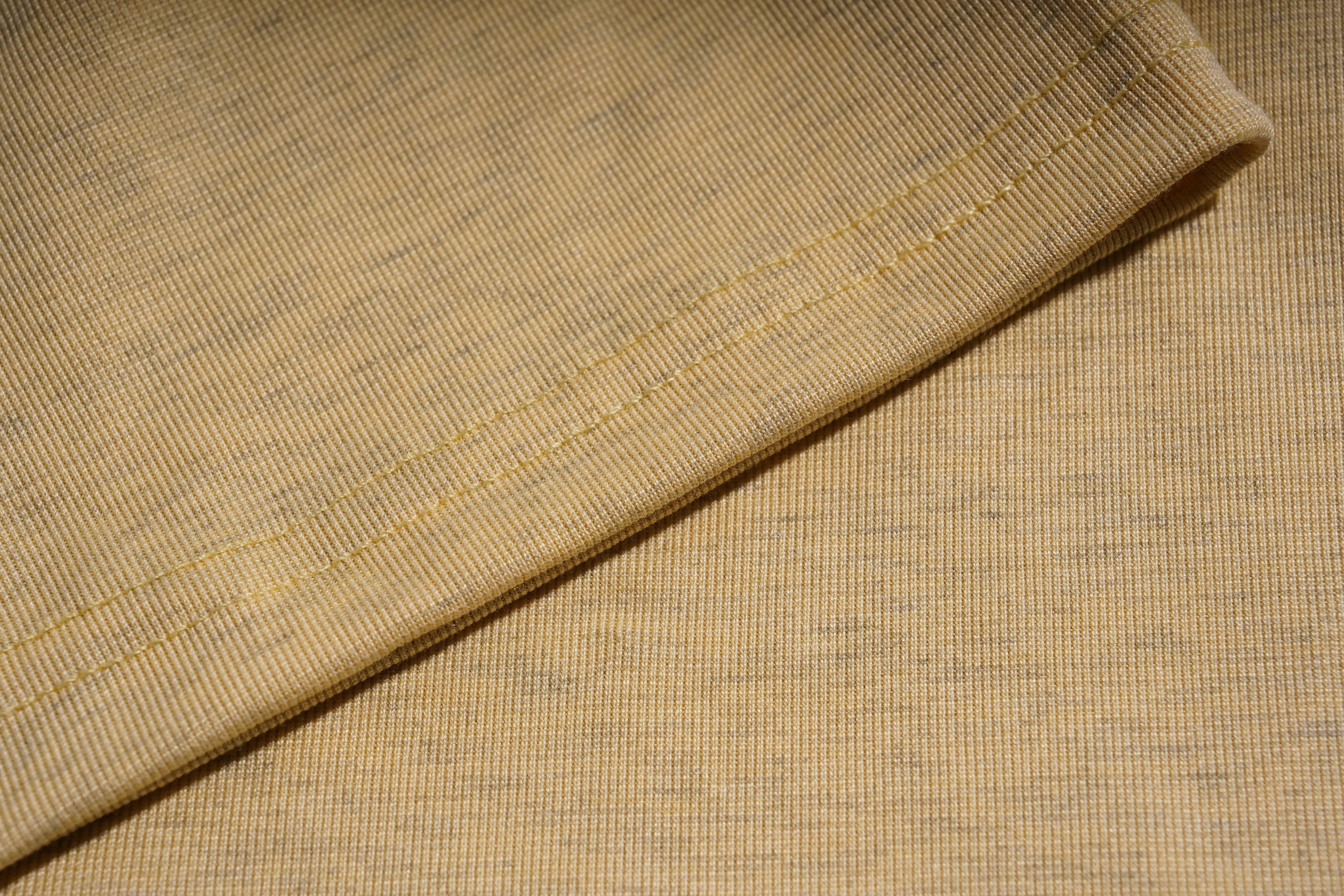 Close-up of beige fabric with a subtle pattern, TCH Yellow Butterfly Pajama Set