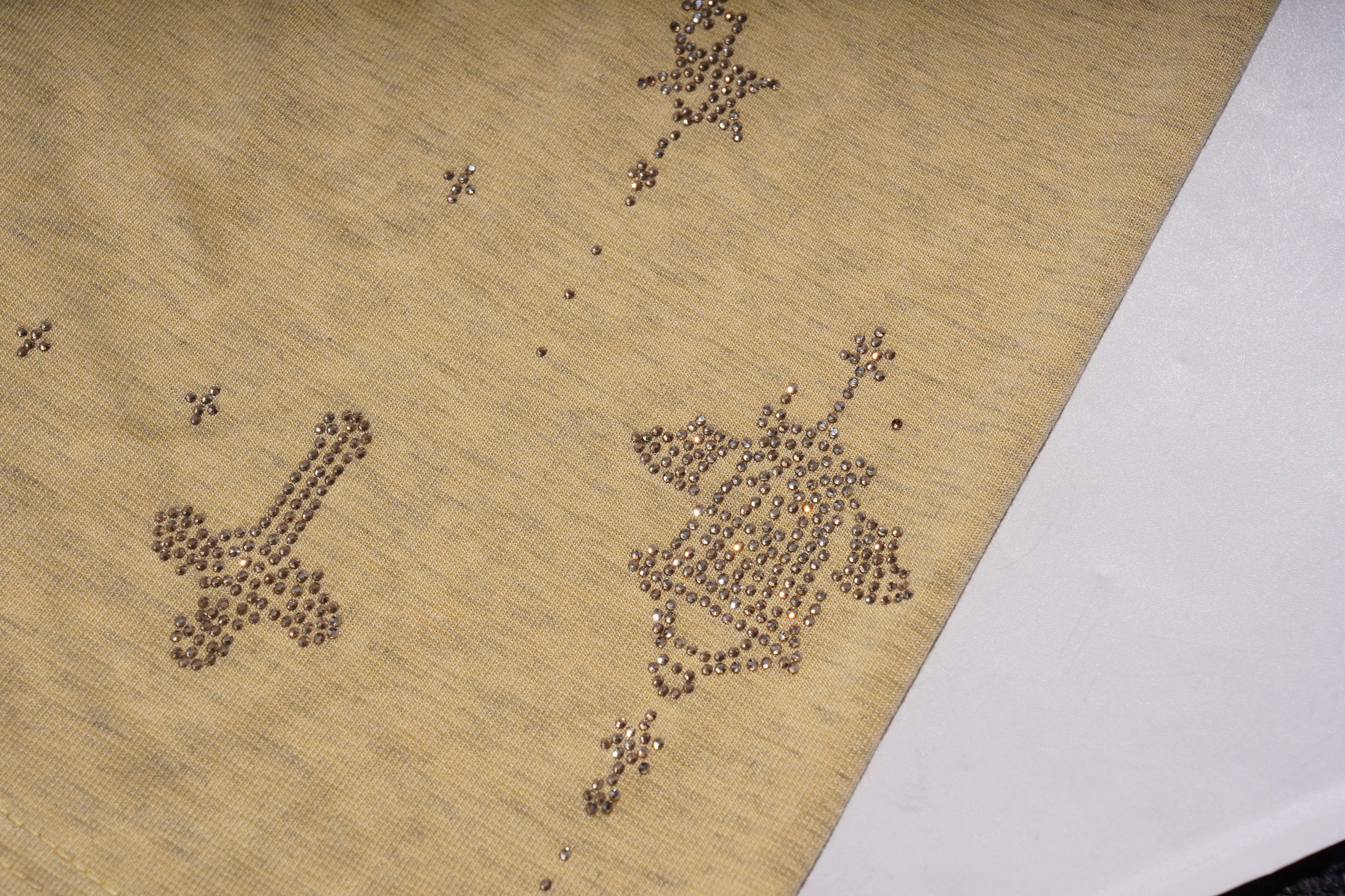 Decorative pattern of small metallic objects on a beige surface with a white edge. TCH Yellow Butterfly Pajama Set