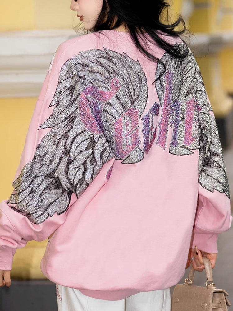 The TCH Unicorn Rhinestone Wings Shiny Sweatshirt&nbsp;blends retro cartoon aesthetics with luxury rhinestone detailing, creating a piece that feels both playful and elevated.