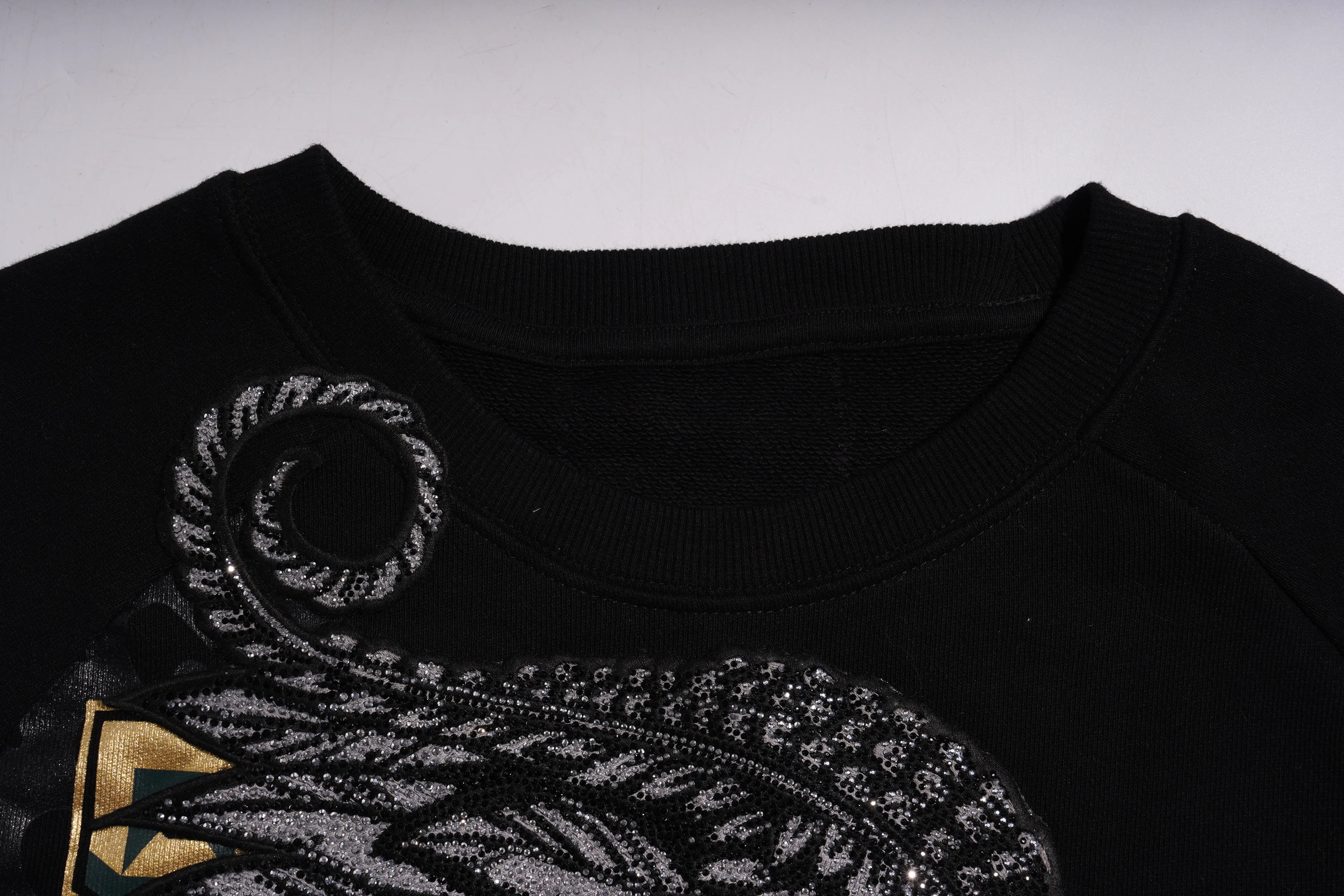 Black garment with intricate silver embroidery on a white background, Rhinestone Wing Embroidered Sweatshirt