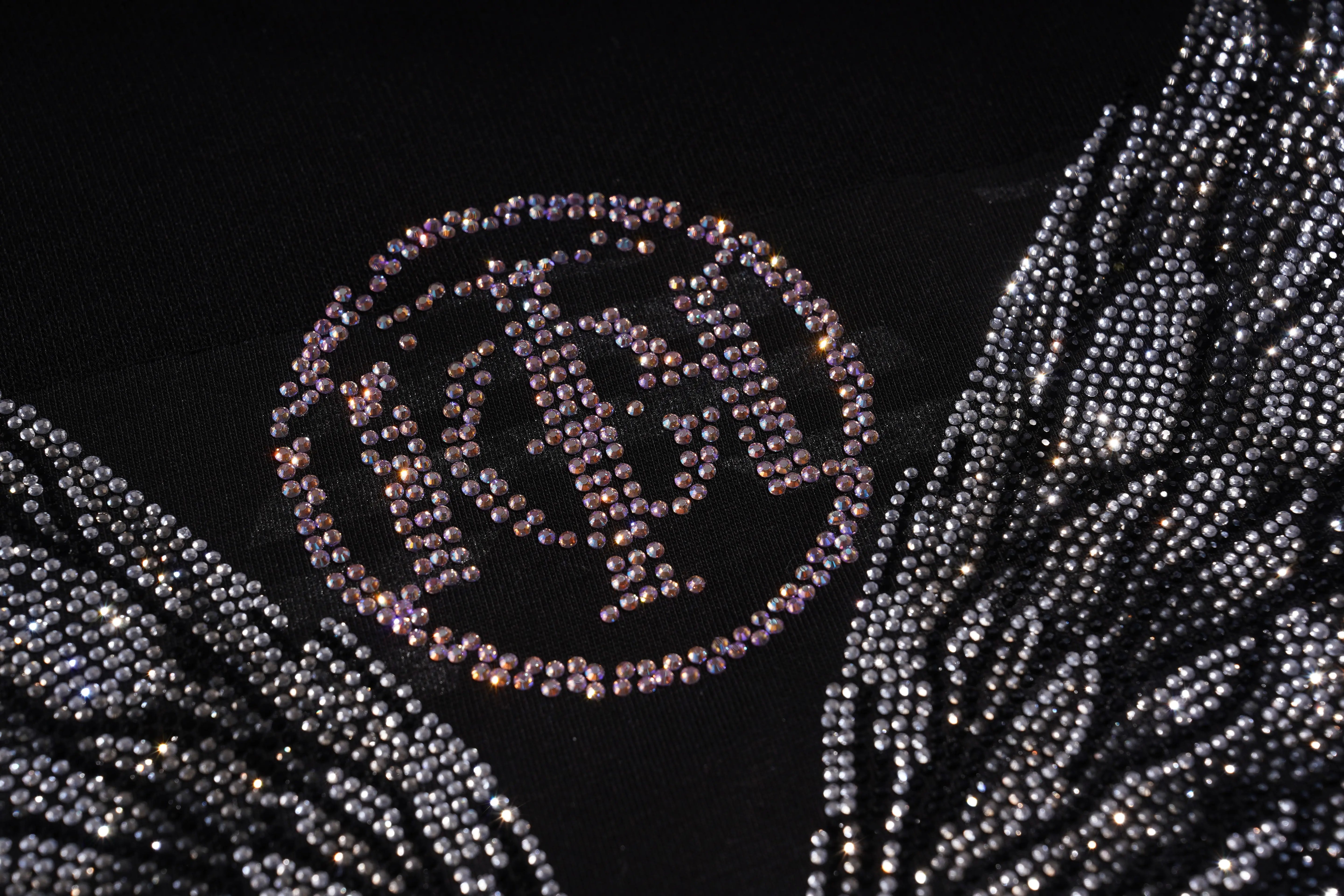 Decorative headpiece with rhinestone embellishments on a black background, TCH 1976 Rhinestone Wings Sweatshirt