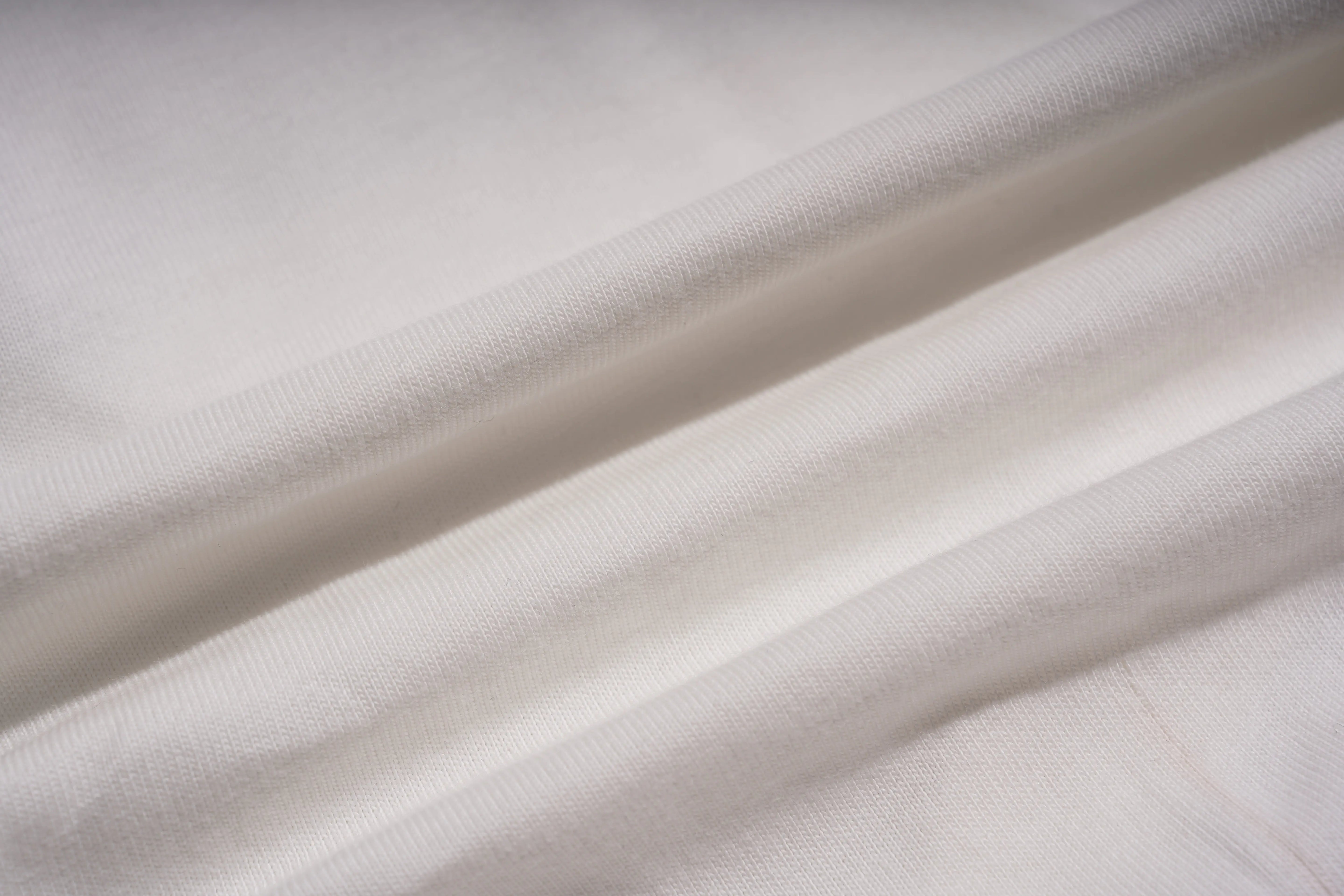 Close-up of white fabric with folds, TCH Anarchy Graphic Rhinestone T-Shirt