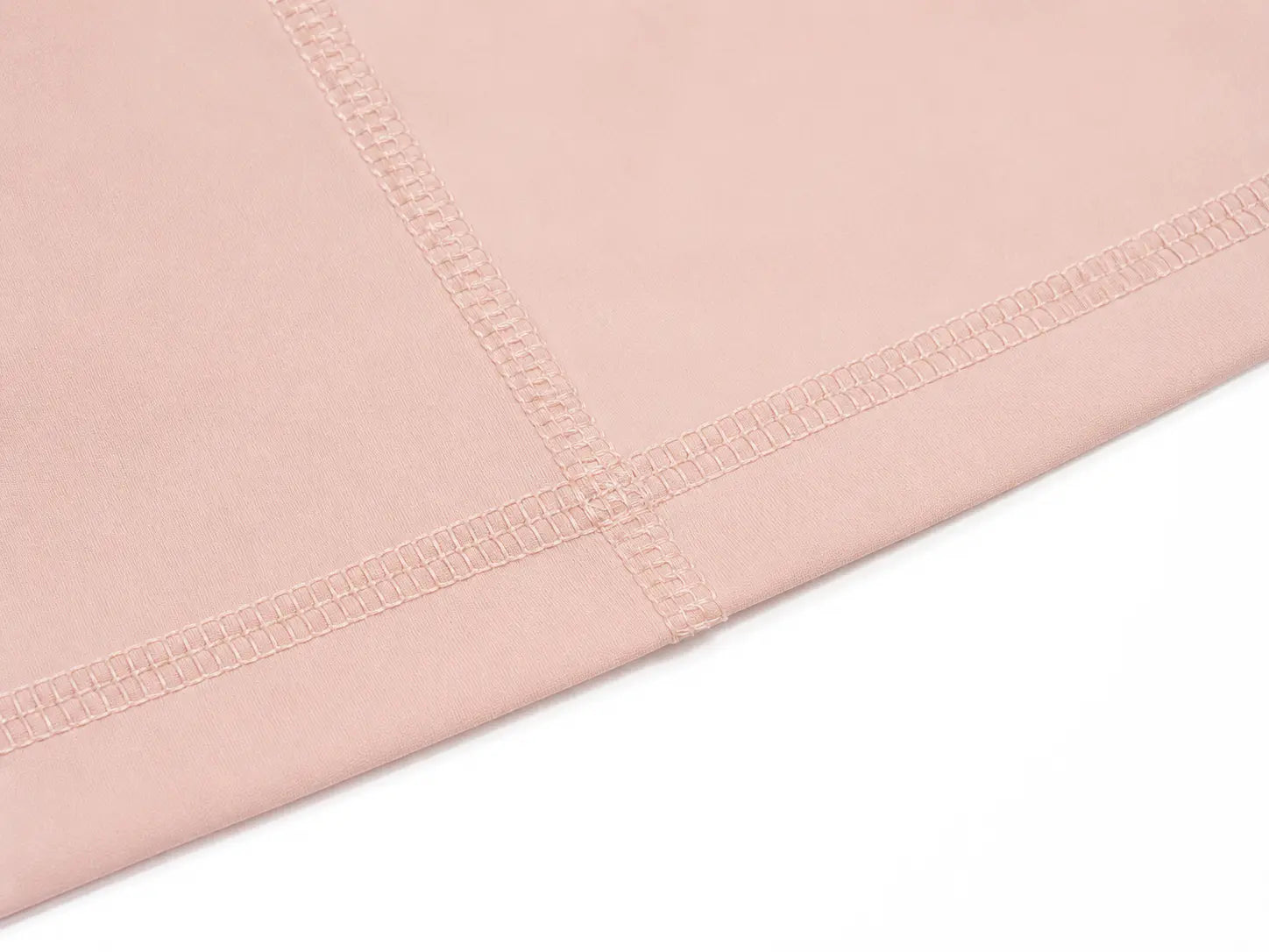 A close-up of a dusty pink fabric, showing the texture and fine stitching along the folded edge, set against a plain white background. TCH Angel Wings Rhinestone Zip-Up Hoodie