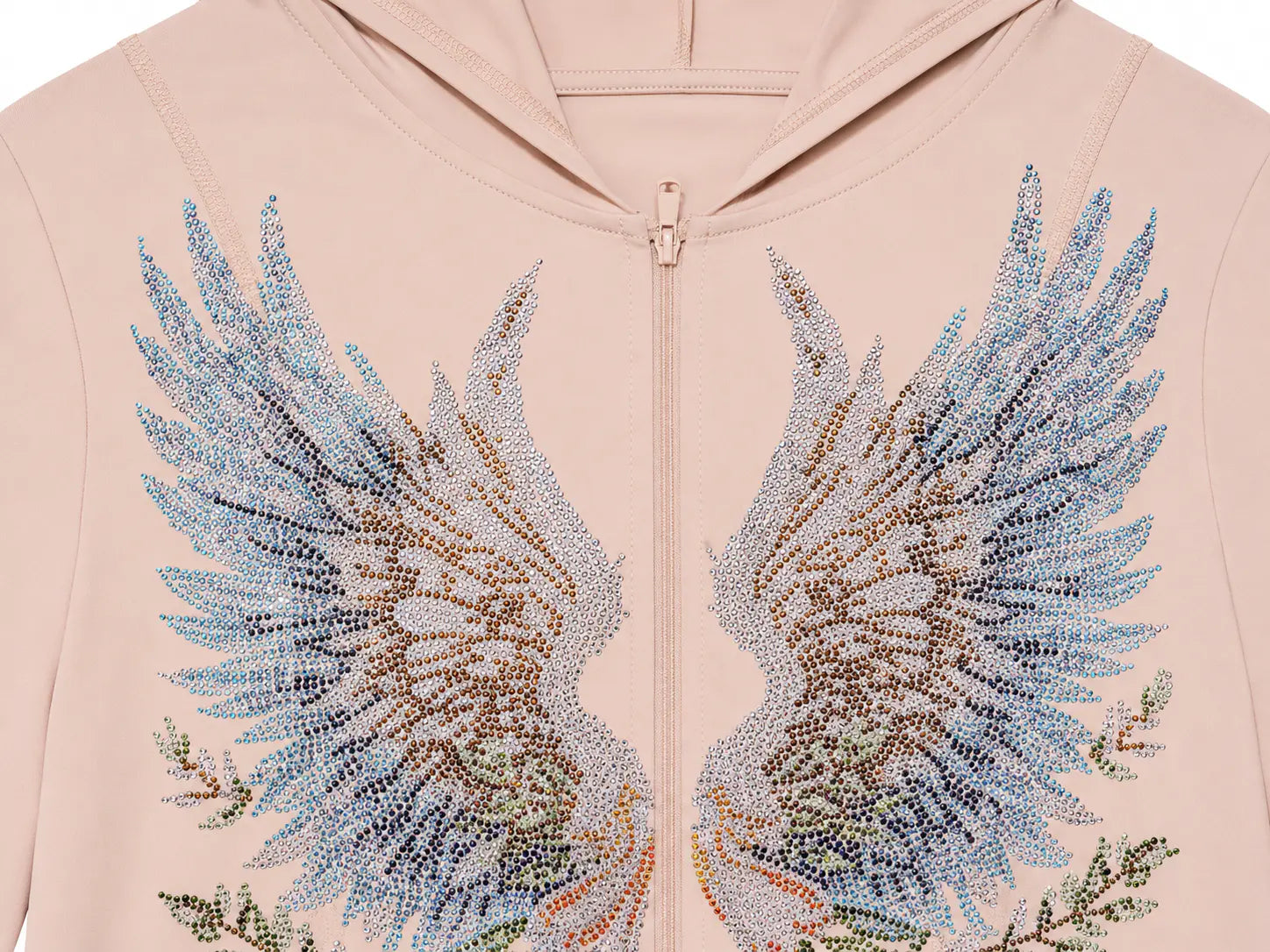 A close-up of a light blush pink zip-up hoodie featuring a large, detailed wing design on the front made of shimmering rhinestones in shades of blue, silver, and gold. TCH Angel Wings Rhinestone Zip-Up Hoodie