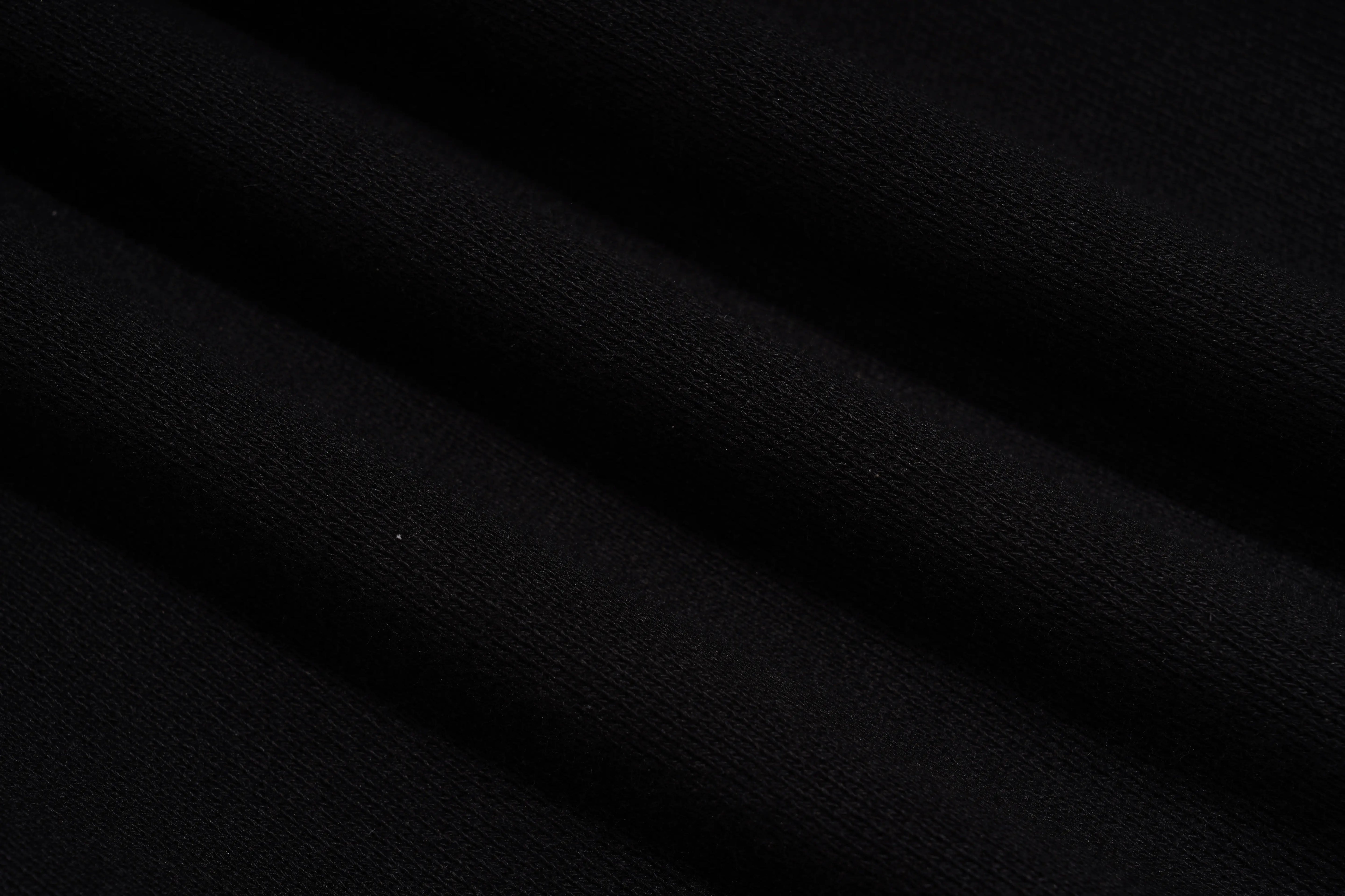 Close-up of black fabric with folds, TCH Bear Sketch Rhinestone Jogger Pants