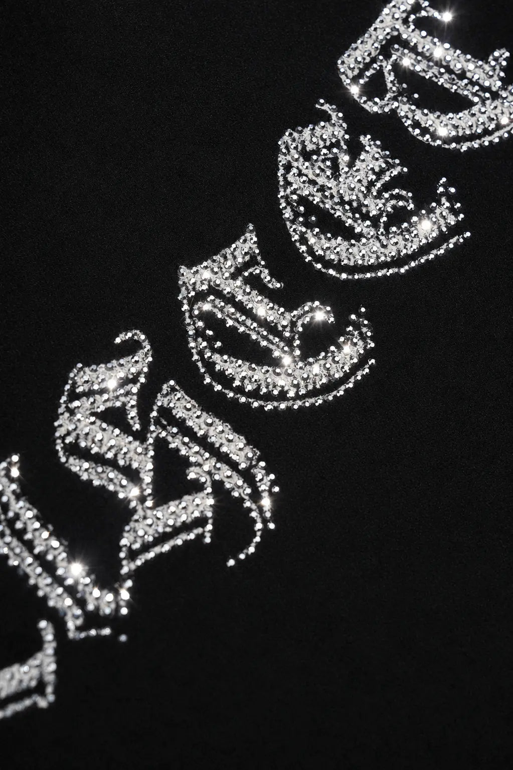A close-up of a black garment featuring large, sparkling silver gothic-style letters spelling out 'BLACQUE' or similar text, with clear rhinestone-like embellishments. TCH Black Old English Techno Graphic Sweatshirt