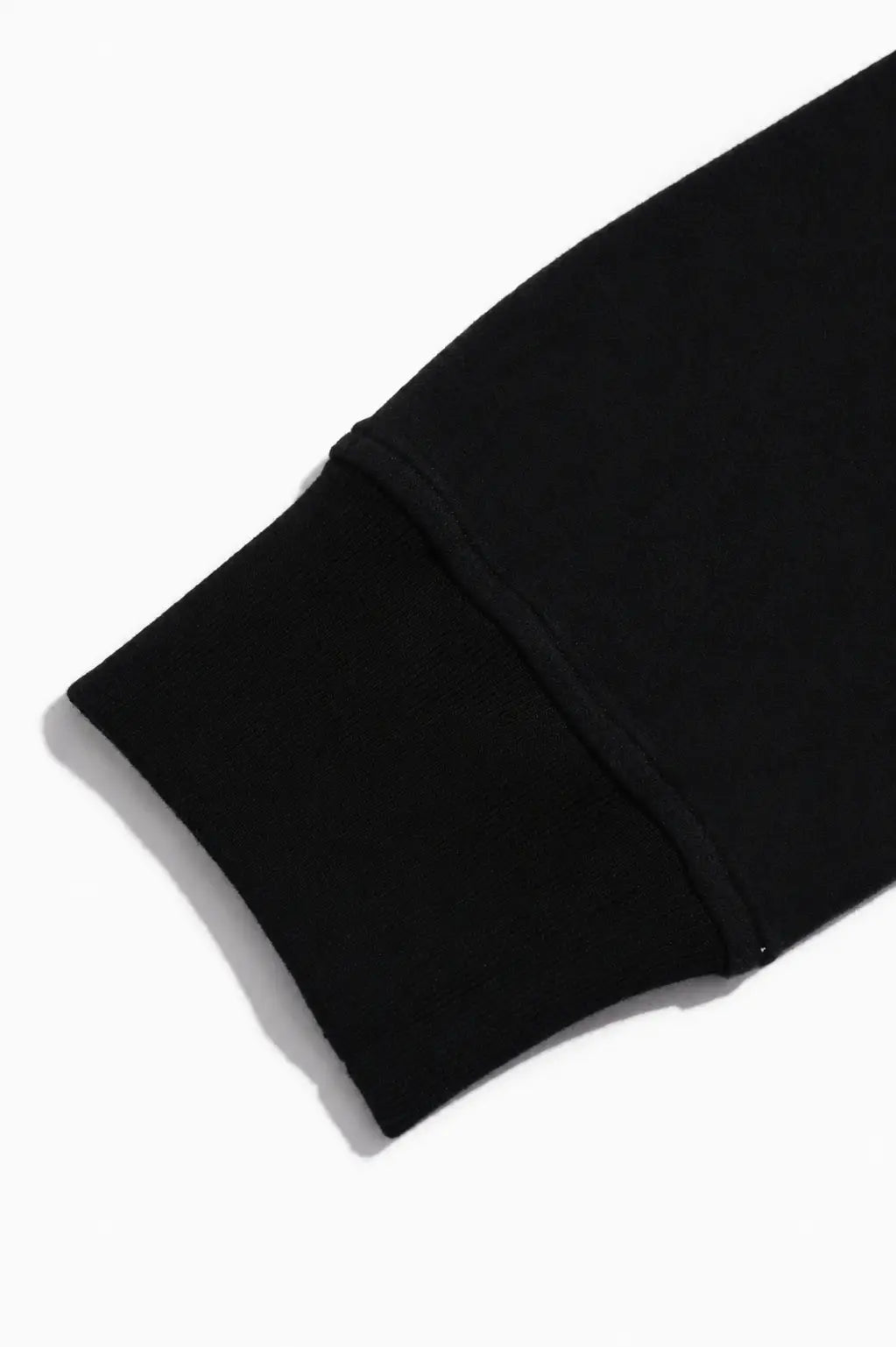 Close-up of a black ribbed knit cuff, likely on a sweatshirt or sweater, shown on a plain white background. TCH Black Old English Techno Graphic Sweatshirt