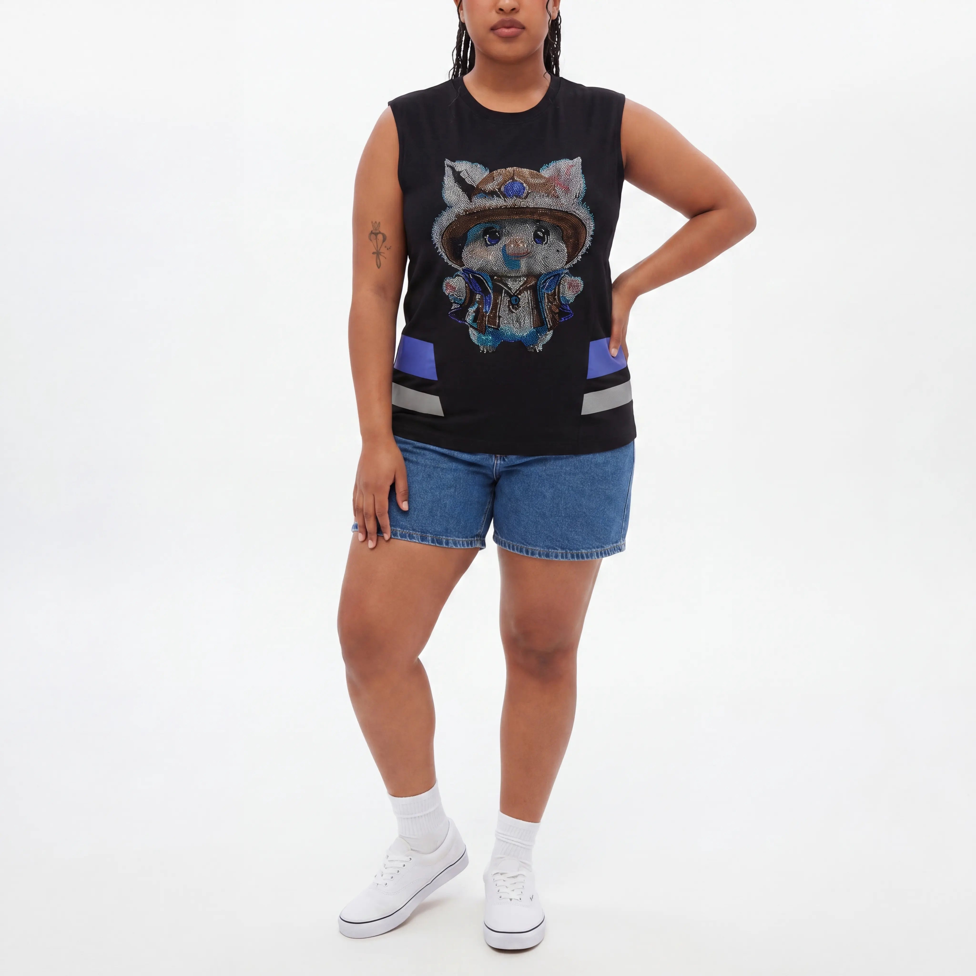 Person wearing a black sleeveless top with a graphic design and denim shorts on a white background, TCH Black Rhinestone Cartoon Pig Sleeveless Top