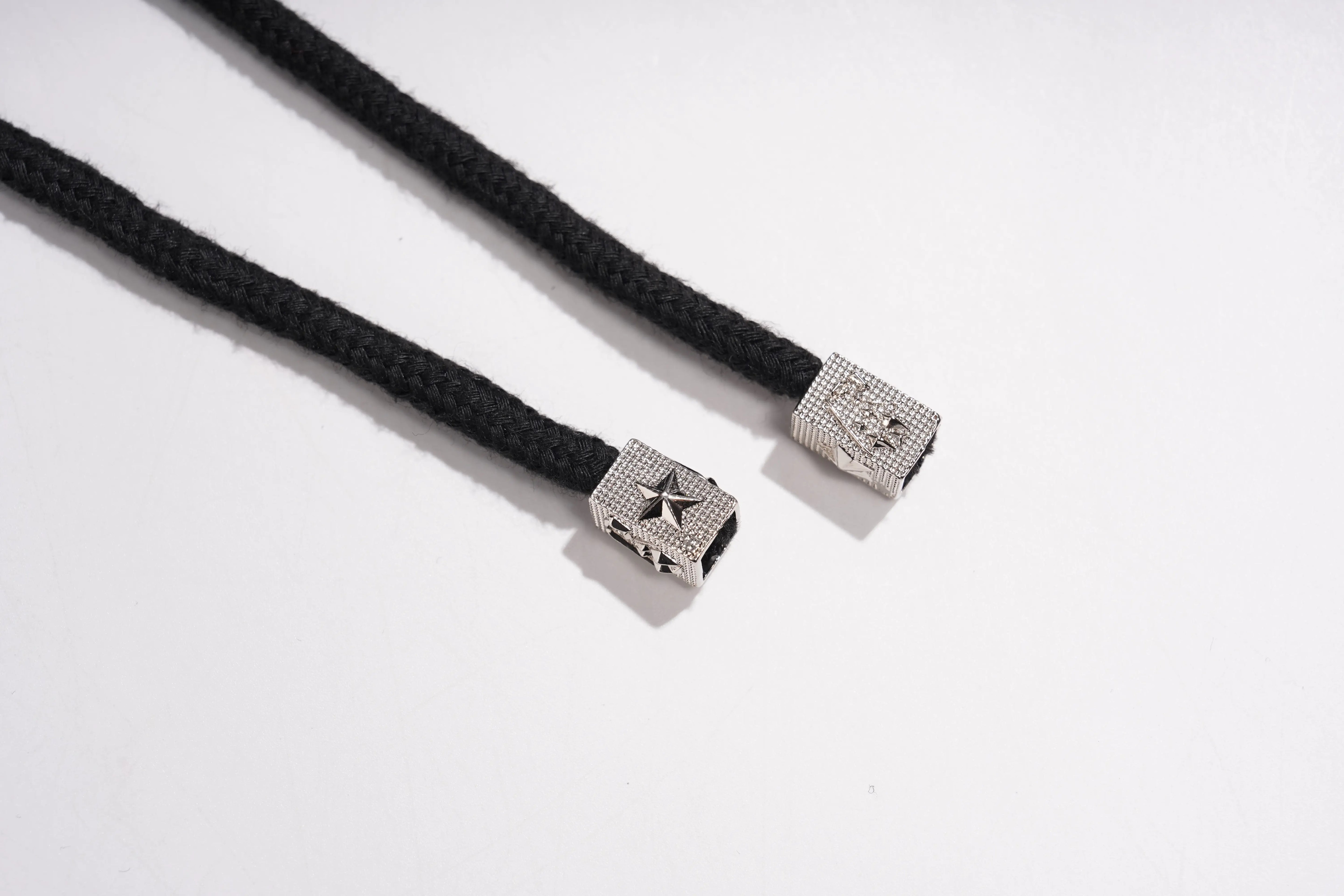 Two black braided cords with silver metal clasps on a white background, TCH Black Rhinestone Side Stripe Jogger Pants