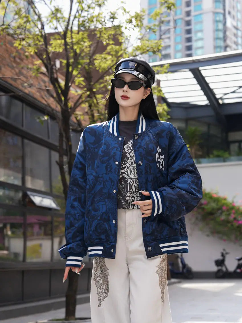 TCH Blue Baroque Pattern Embroidered Varsity Jacket TCH blue varsity jacket Blue baroque pattern jacket Gothic graphic varsity jacket Navy blue streetwear jacket Baroque print bomber jacket Embroidered varsity jacket Gothic lettering jacket Blue snap-button jacket Ornamental print streetwear jacket TCH graphic bomber jacket