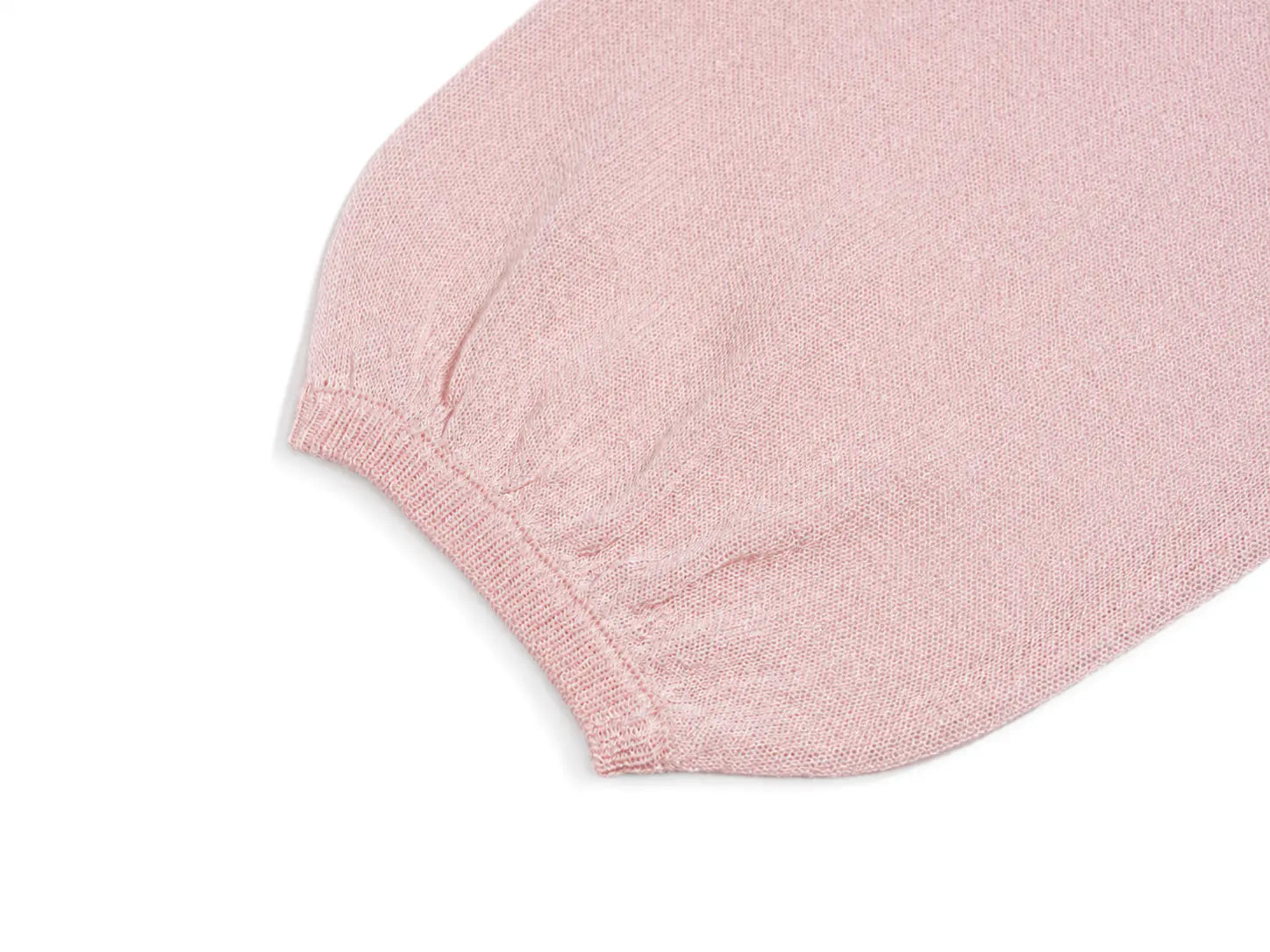 A close-up detail shot of a light pink knit fabric, showing a ribbed cuff and a fine textured weave on a white background. TCH Blue Rhinestone Angel Wings Cropped Hoodie