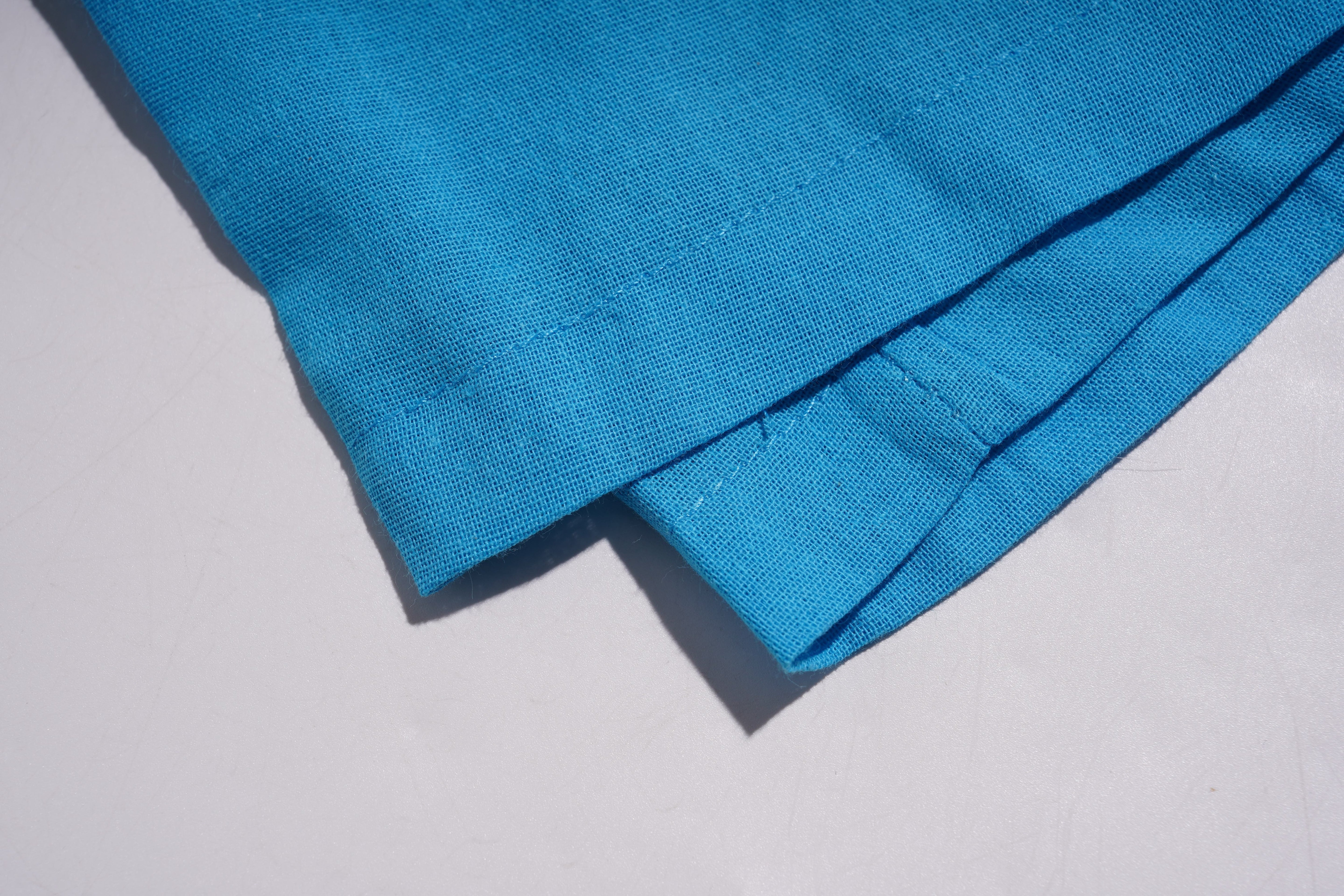 Close-up of blue fabric on a light gray background, TCH Blue Rhinestone Bow Matching Set