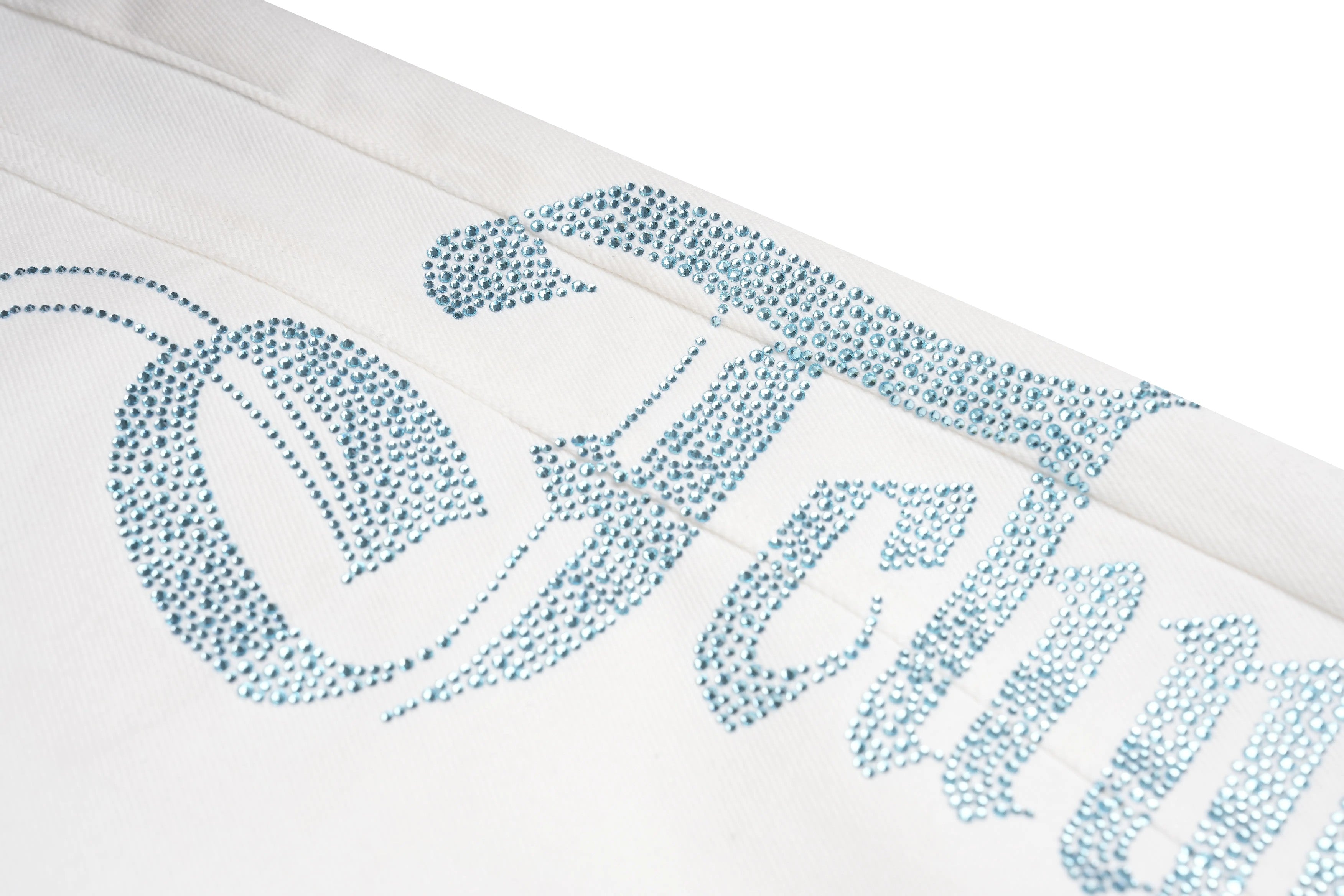 Textured blue pattern on a white background, TCH Blue Rhinestone Logo & “TchmucH” White Denim Jeans