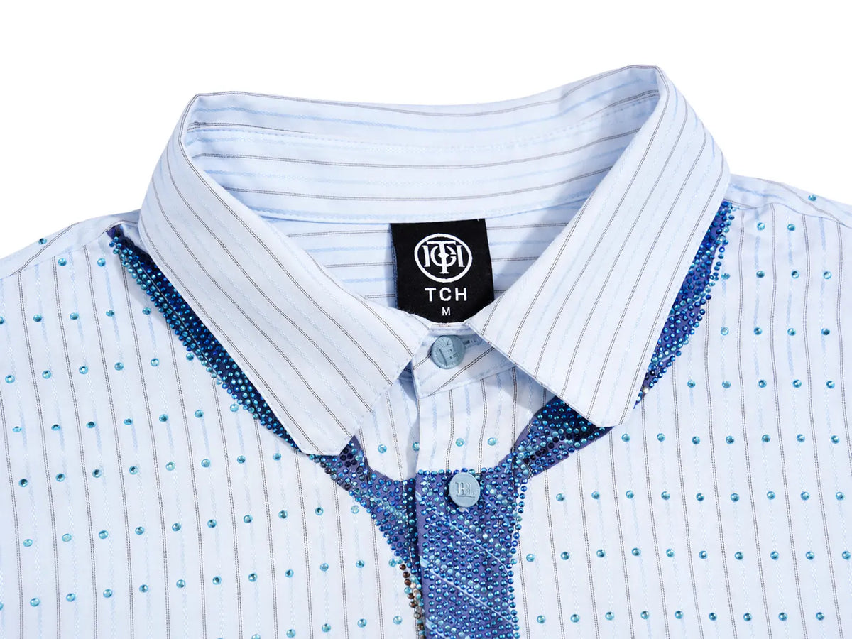 Close-up of a children's collared shirt with a white base, thin blue pinstripes, blue sequined trim along the collar and placket, and small blue rhinestone-like dots across the front. A black neck label reads TCH. TCH Blue Striped Tie Detail Button-Up Shirt