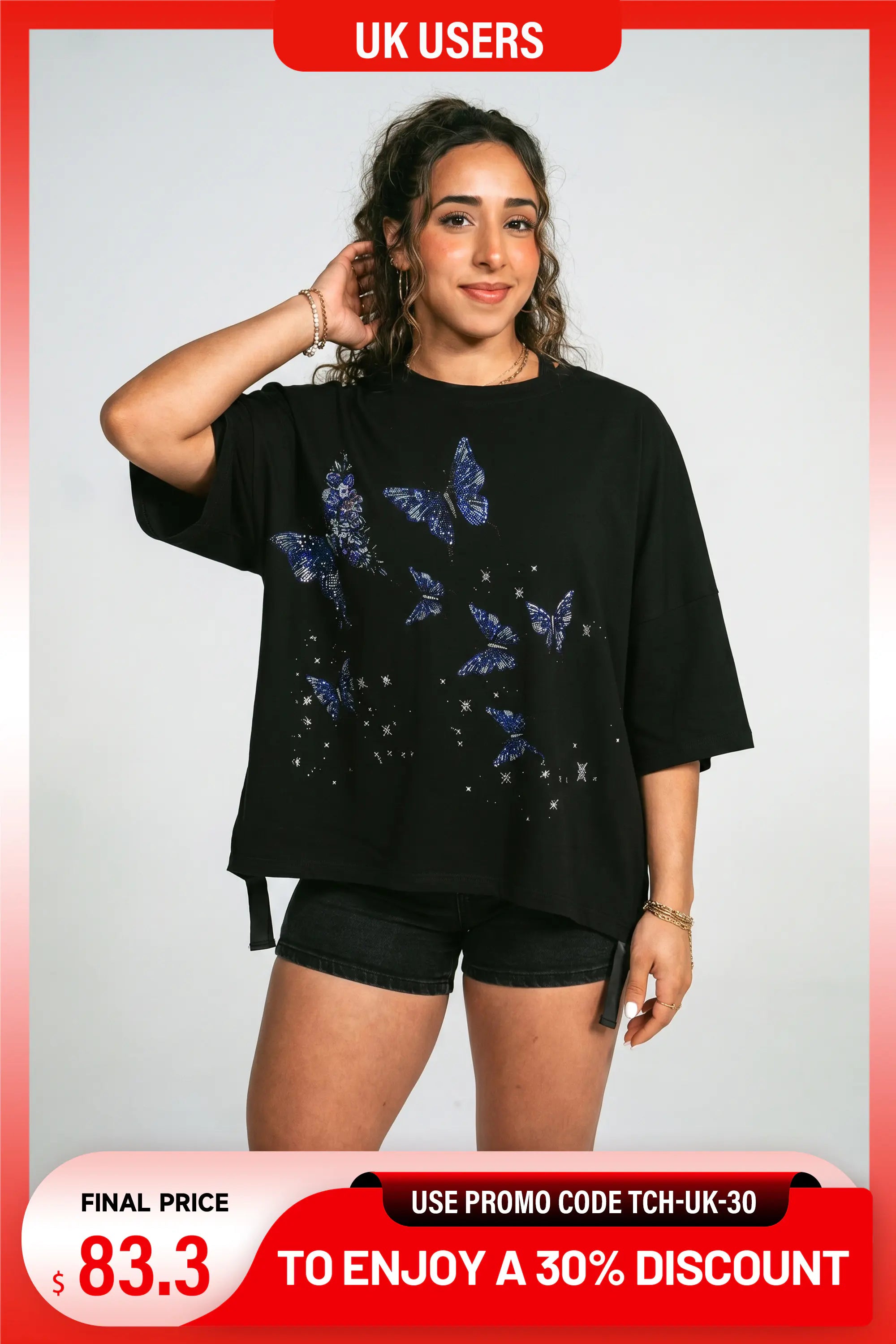 A woman modeling a black oversized short-sleeve t-shirt with a blue butterfly graphic print on the front, paired with black shorts, set against a light gray background with promotional text overlays. TCH Butterfly Rhinestone Oversized T-Shirt