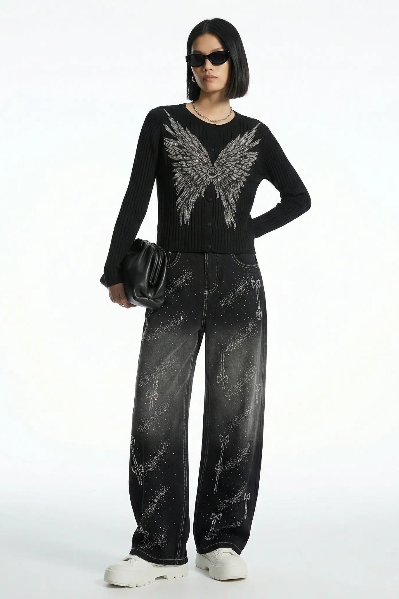 Person wearing a black sweater with angel wings and black pants on a white background, TCH Celestial Rhinestone Wide-Leg Black Jeans