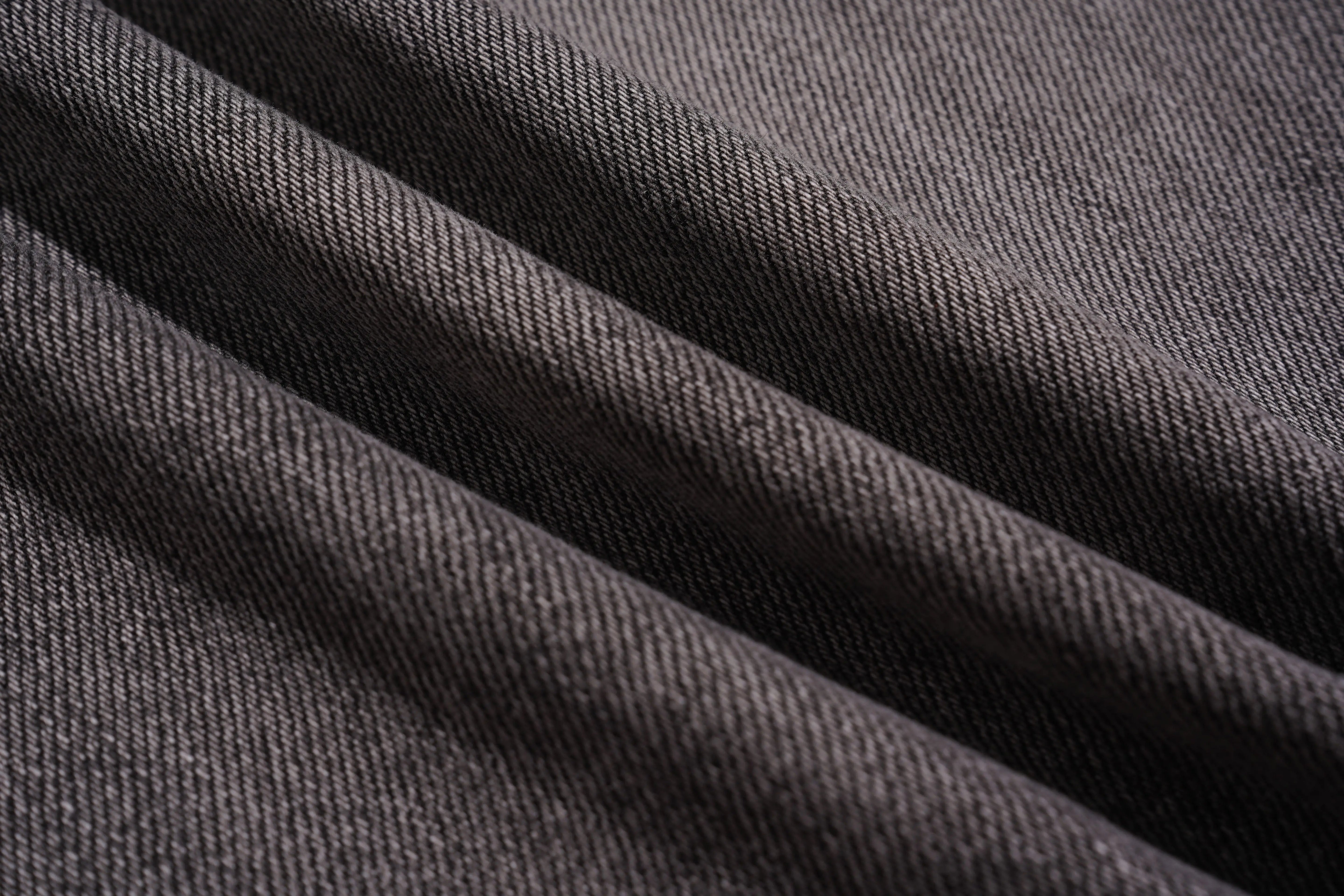 Close-up of dark gray fabric with visible texture, TCH Celestial Rhinestone Wide-Leg Black Jeans