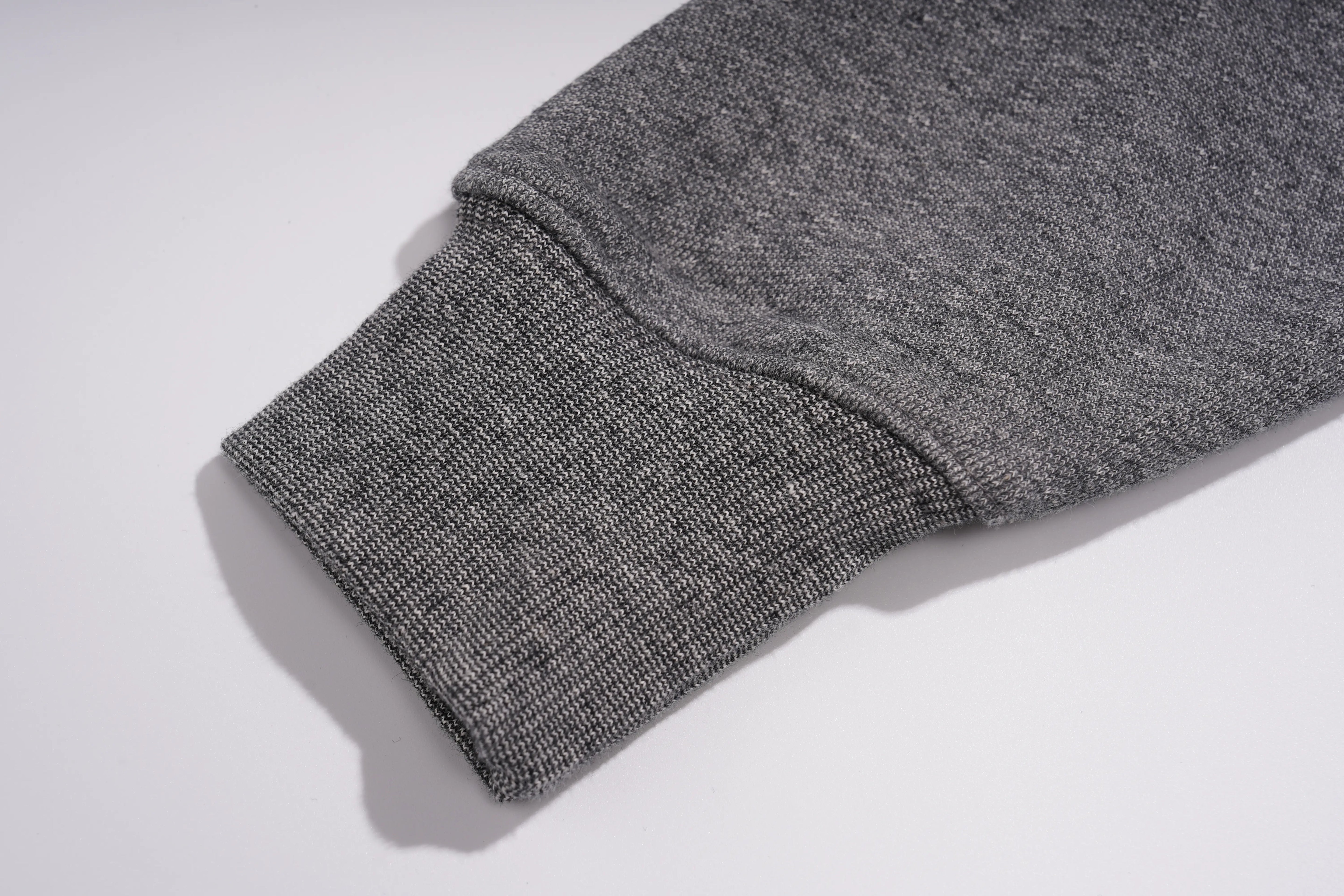 Close-up of a gray knit sleeve with a ribbed cuff, photographed on a clean white background. TCH Colorful Rhinestone Teddy Bear Crewneck Sweatshirt
