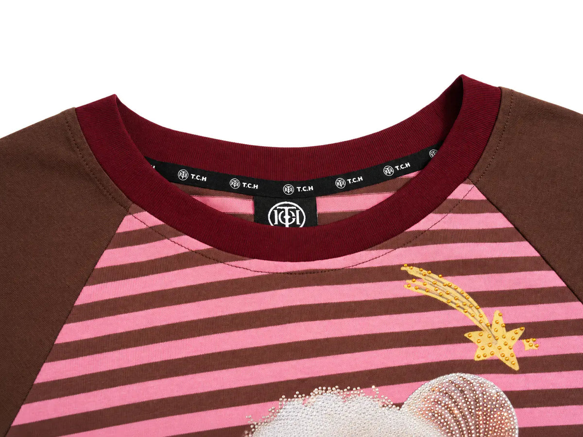 Close-up of a TCM raglan t-shirt featuring pink and brown horizontal stripes, solid brown sleeves, a dark red collar, and a yellow embroidered shooting star. TCH Cute Lamb Pink Striped Raglan Long Sleeve Top