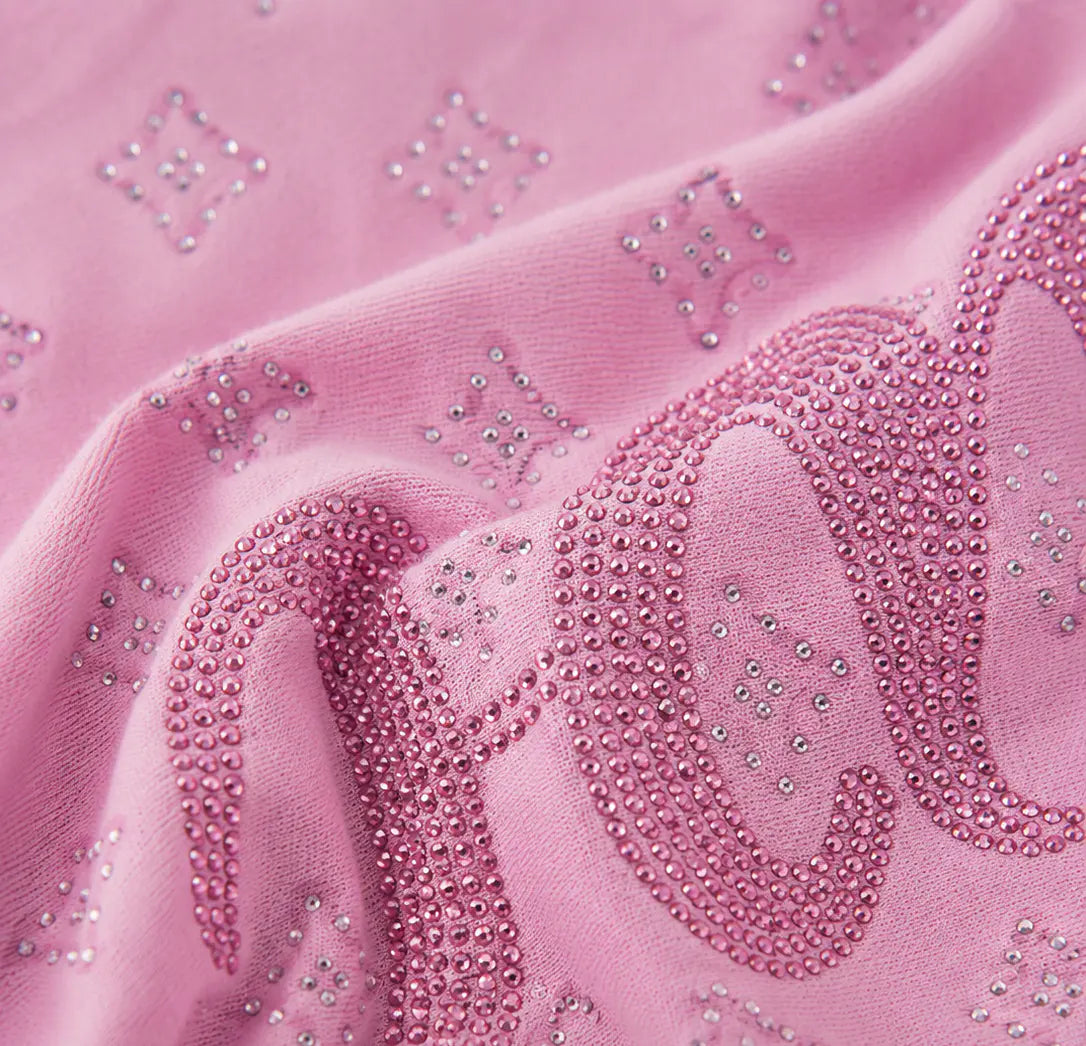 A close-up of pink fabric with large cursive lettering and small rhinestone star motifs, showing the material texture and embellishment details. TCH Cute Teddy Bear Rhinestone Oversized T-Shirt Dress