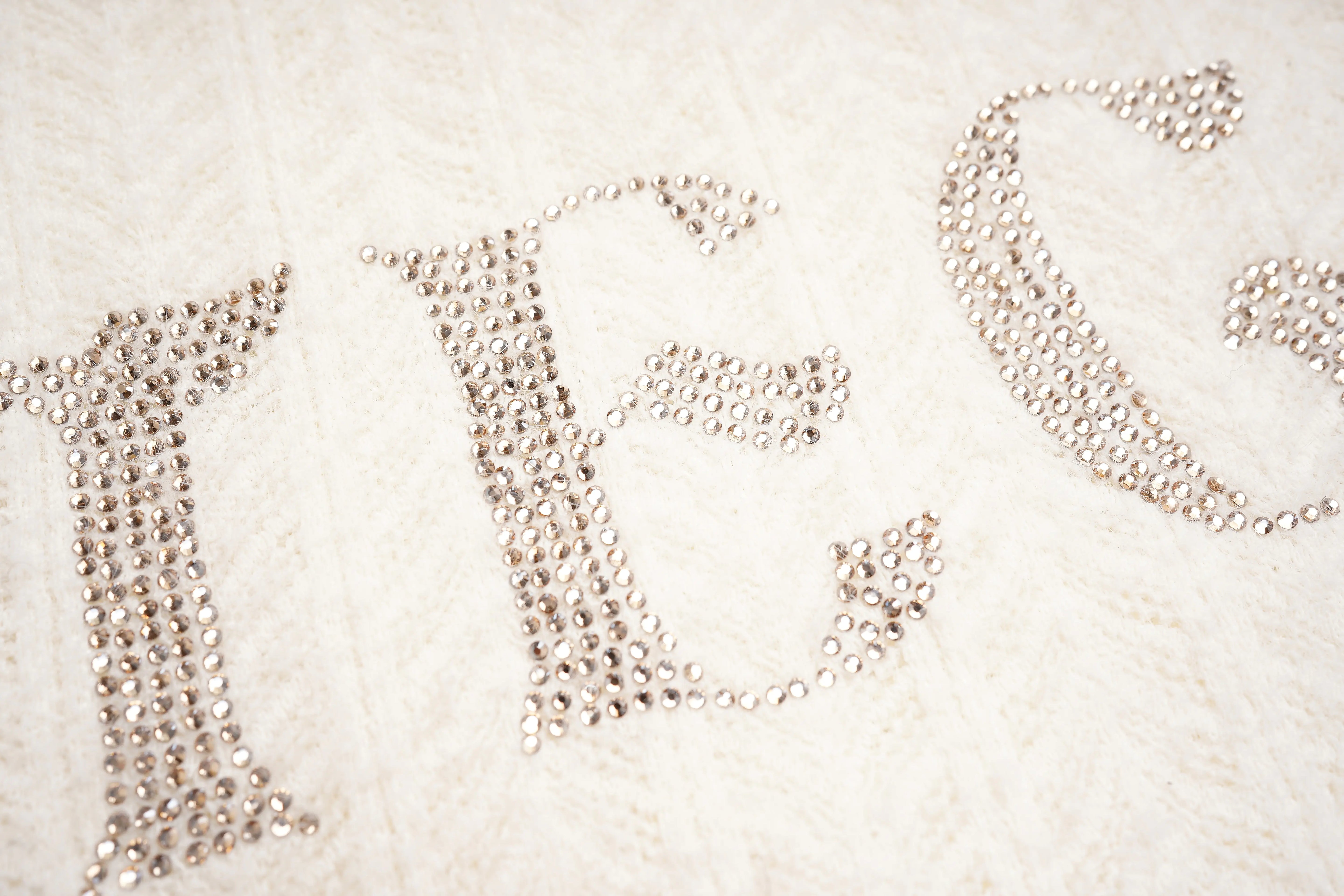Decorative text made of small beads on a textured surface, TCH Dual-Layer Mesh V-Neck Rhinestone Bow Beige Crop Turtleneck Top