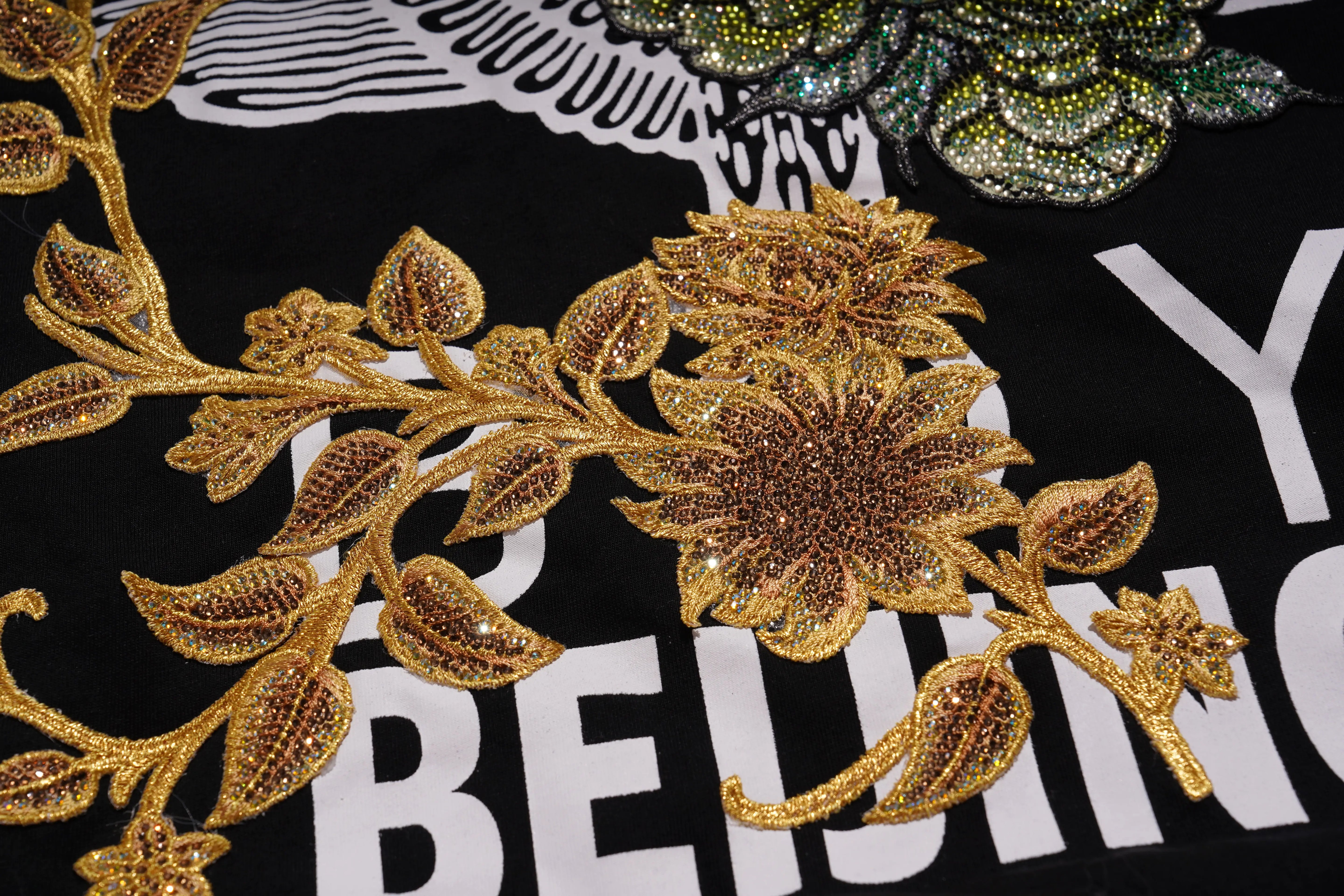 Gold floral embroidery on a black background with text, TCH Embroidered Floral Butterfly Rhinestone T-Shirt