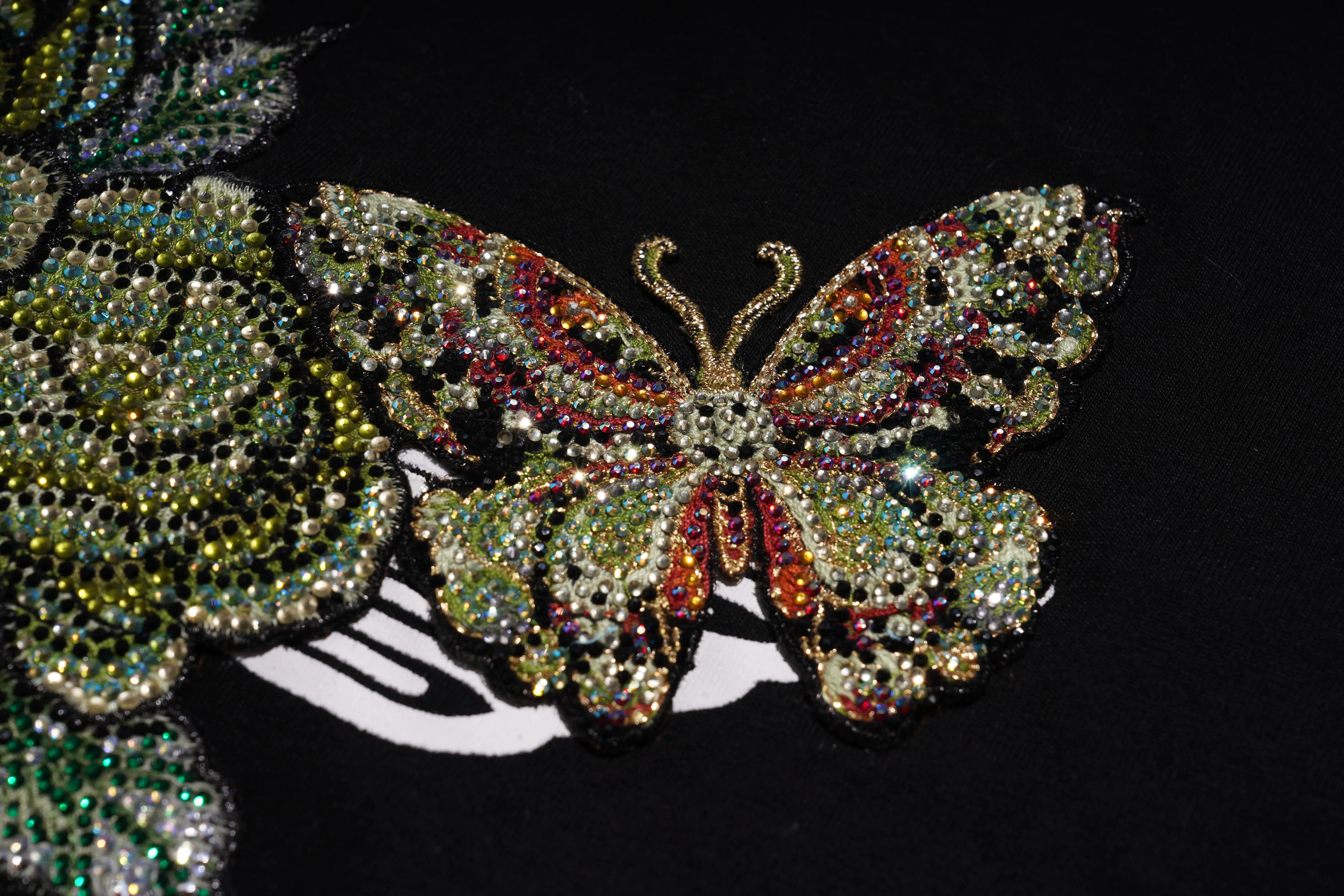 Decorative butterfly with gemstones on a black background, TCH Embroidered Floral Butterfly Rhinestone T-Shirt