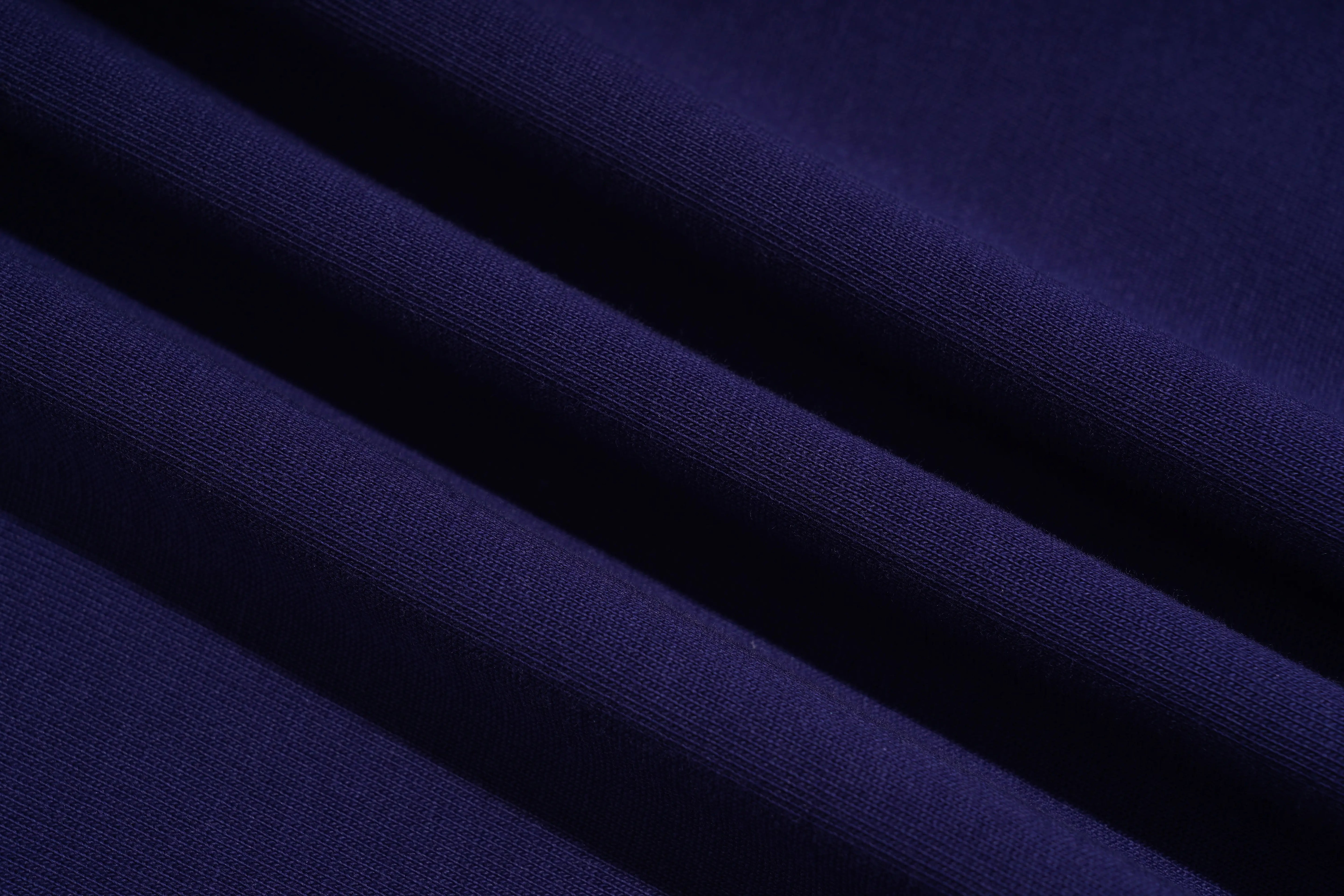 A close-up of draped dark navy blue fabric with soft diagonal folds showing a fine ribbed texture. TCH Floral Embroidery Graphic Navy Blue T-Shirt