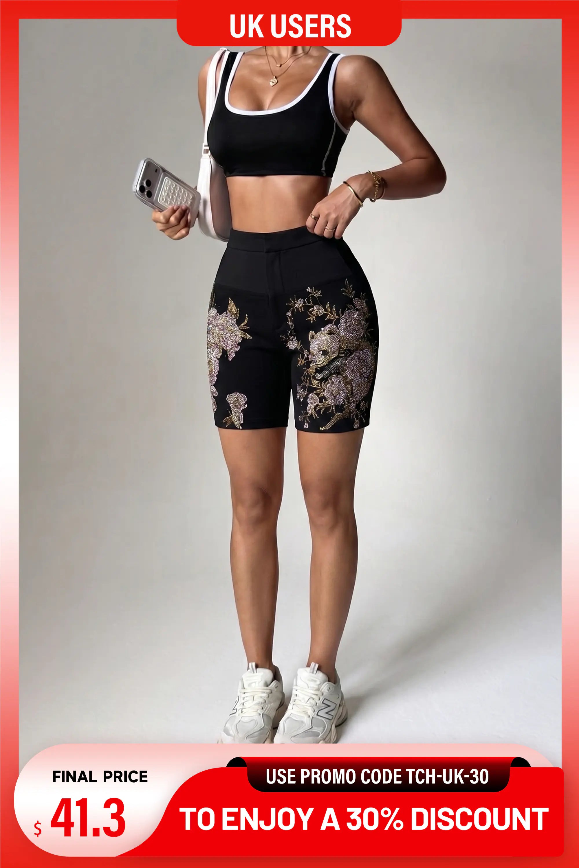 A woman modeling a black sports bra and matching high-waisted black athletic shorts with a floral print, standing against a light gray studio background. The image includes promotional text banners at the top and bottom. TCH Floral Rhinestone Garden Shorts – Black Streetwear Tailored Fit