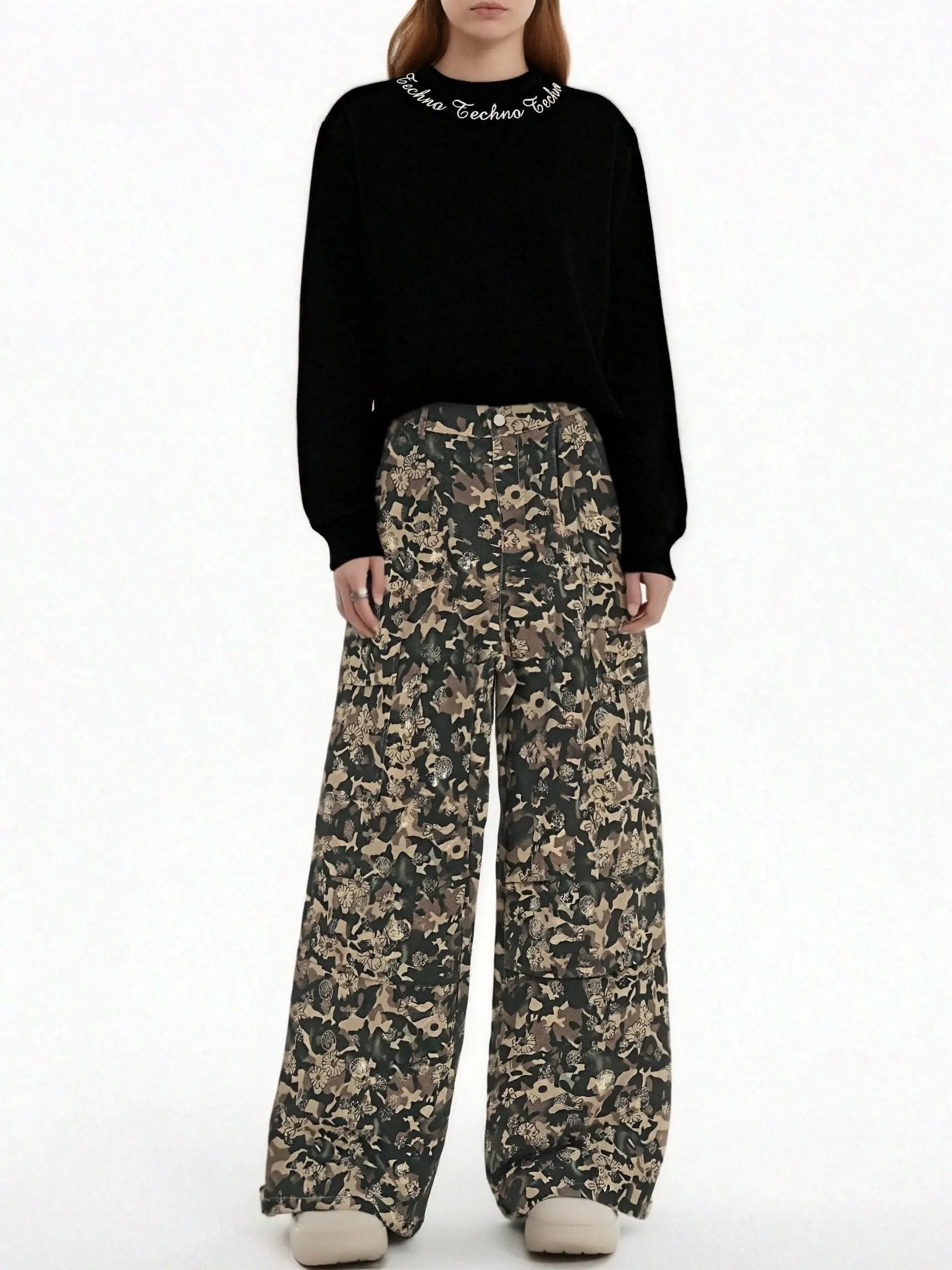 Person wearing a black sweater and camouflage pants on a white background, TCH Gold Snowflake Rhinestone Camo Denim Jeans