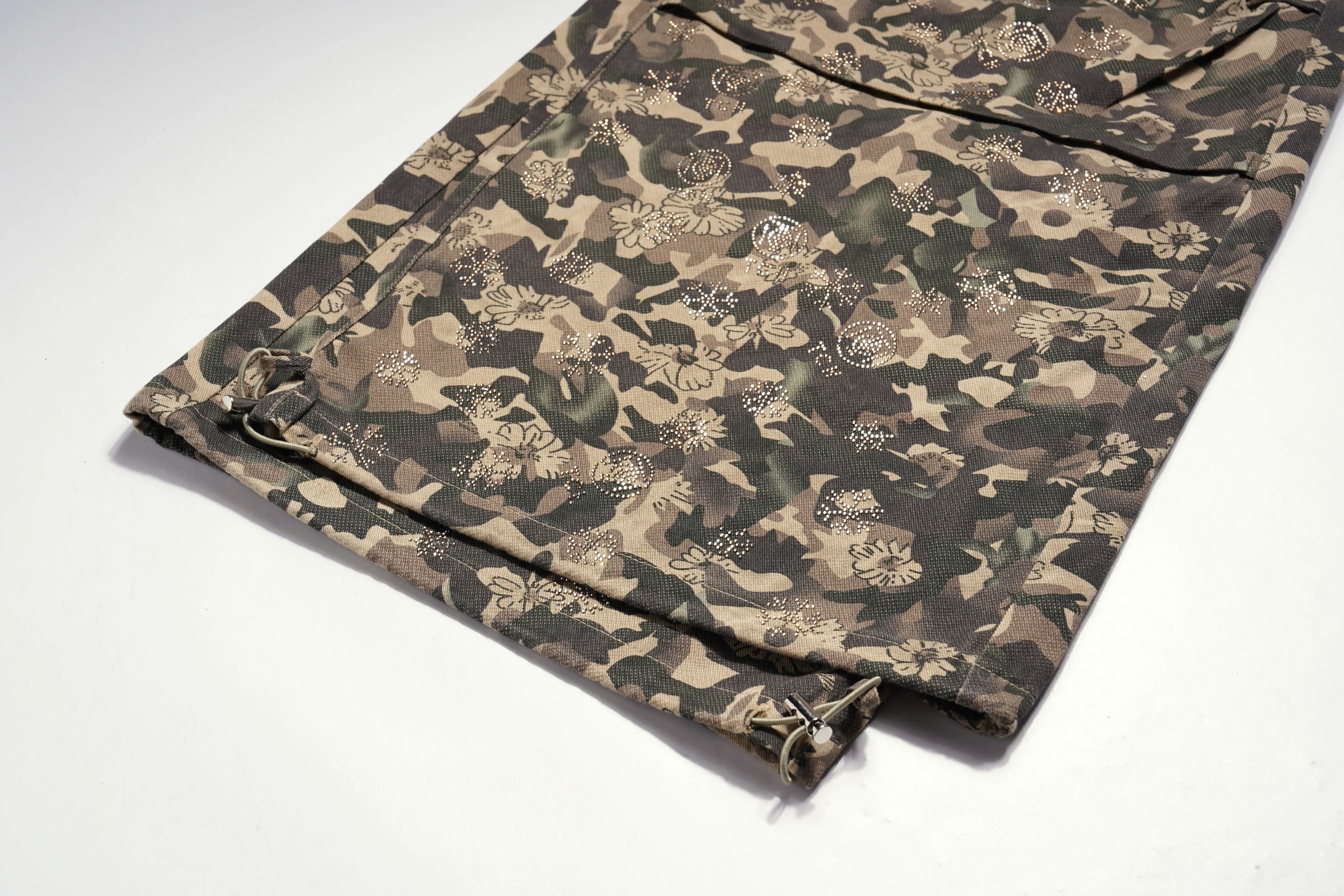 Folded camouflage fabric on a white background, TCH Gold Snowflake Rhinestone Camo Denim Jeans