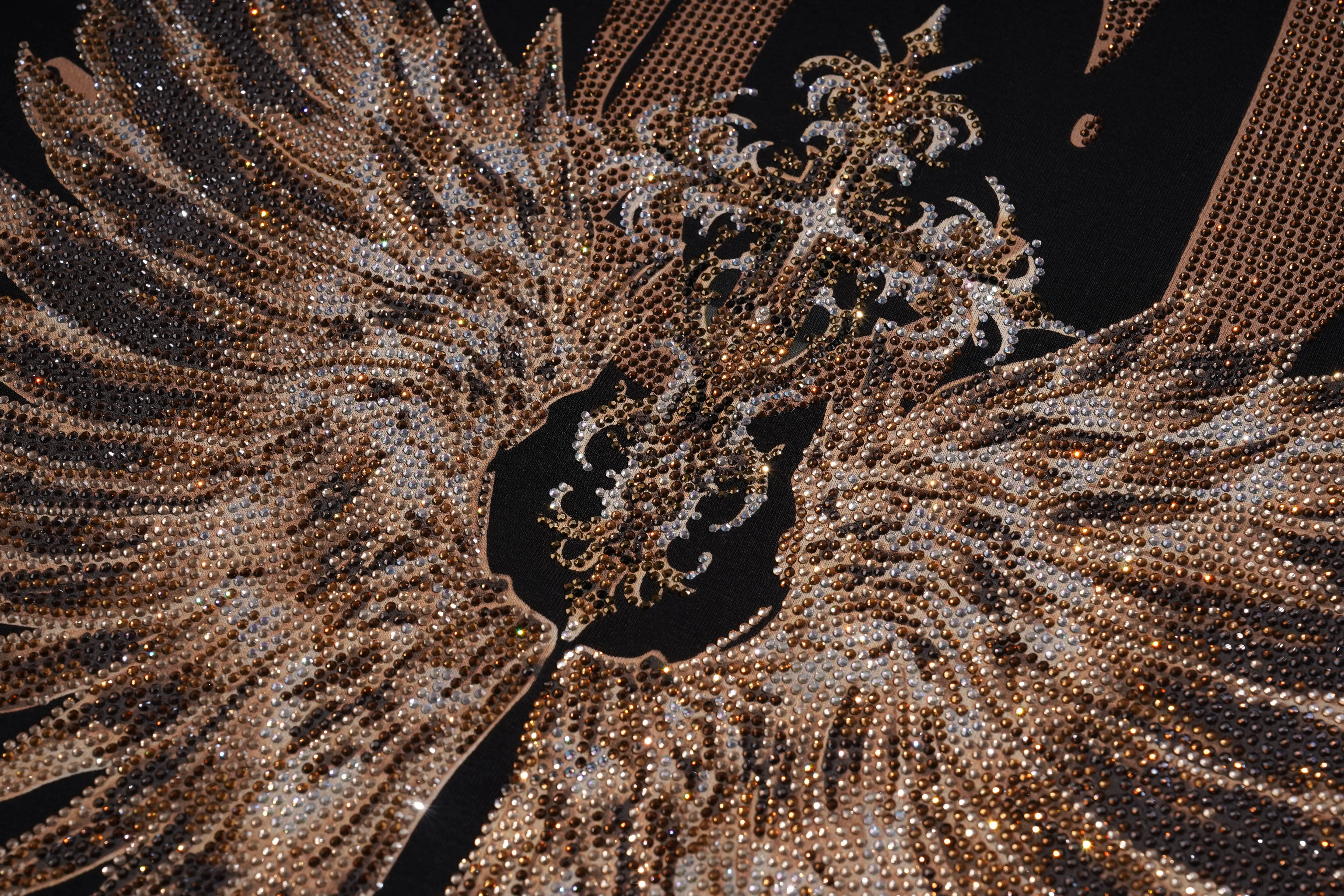 A close-up of a highly detailed, ornate double-headed eagle emblem or decorative piece made entirely of sparkling gold-toned rhinestones and crystals, set against a solid black background. TCH Golden Wing Techno Oversized Graphic T-Shirt