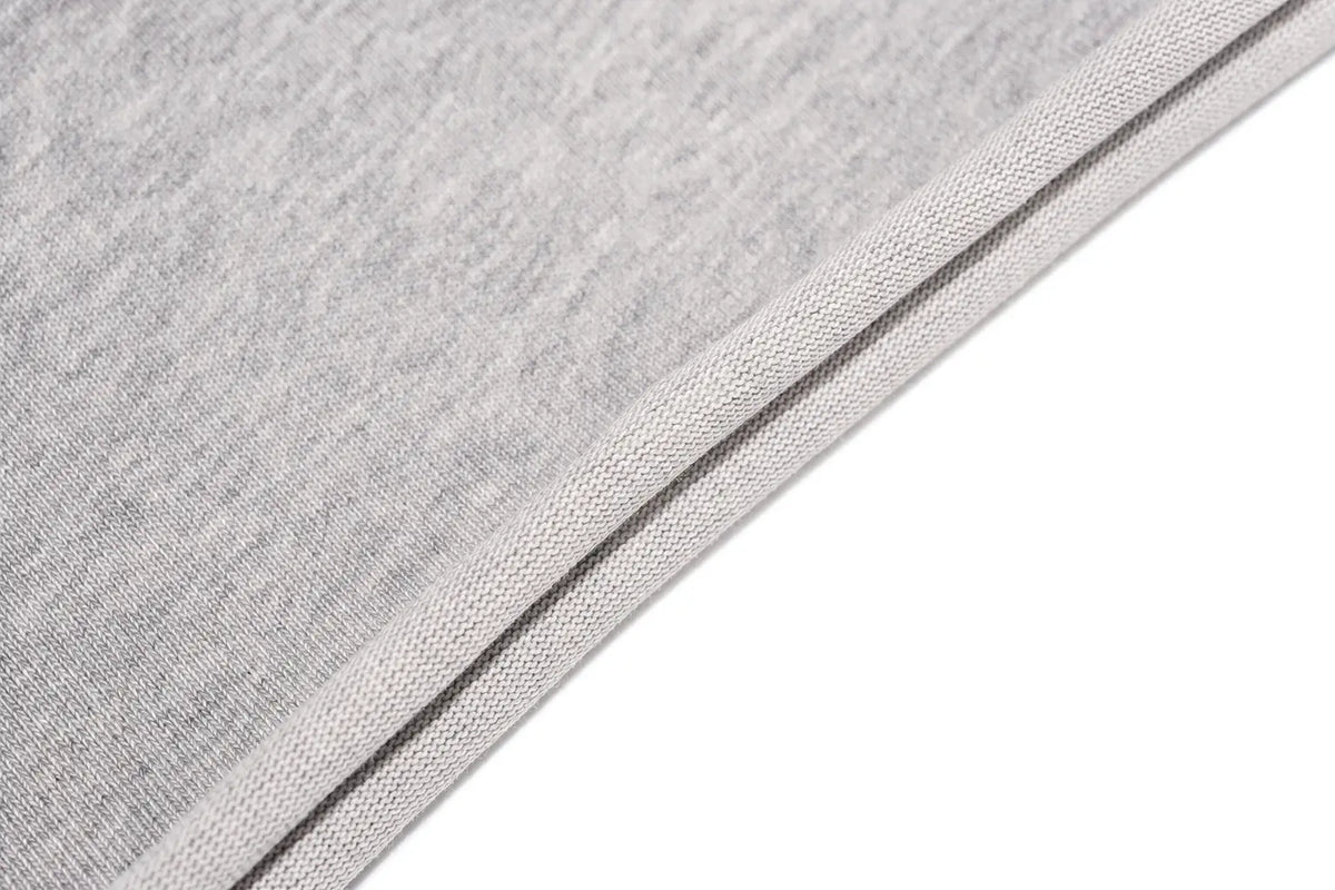 Close-up of a light gray heathered fabric with a double stitched edge, shown against a solid white background. TCH Gothic Rhinestone Lace Pattern Flared Sleeve Long Sleeve Top