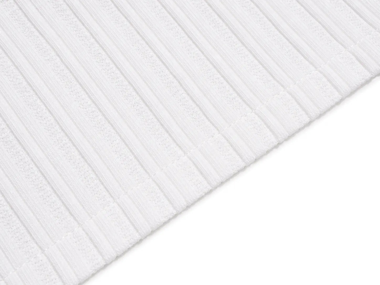 A close-up of a white ribbed fabric or textile surface with vertical ridges, shown diagonally against a white background. TCH Gothic Rhinestone Letter Ribbed Henley T-Shirt