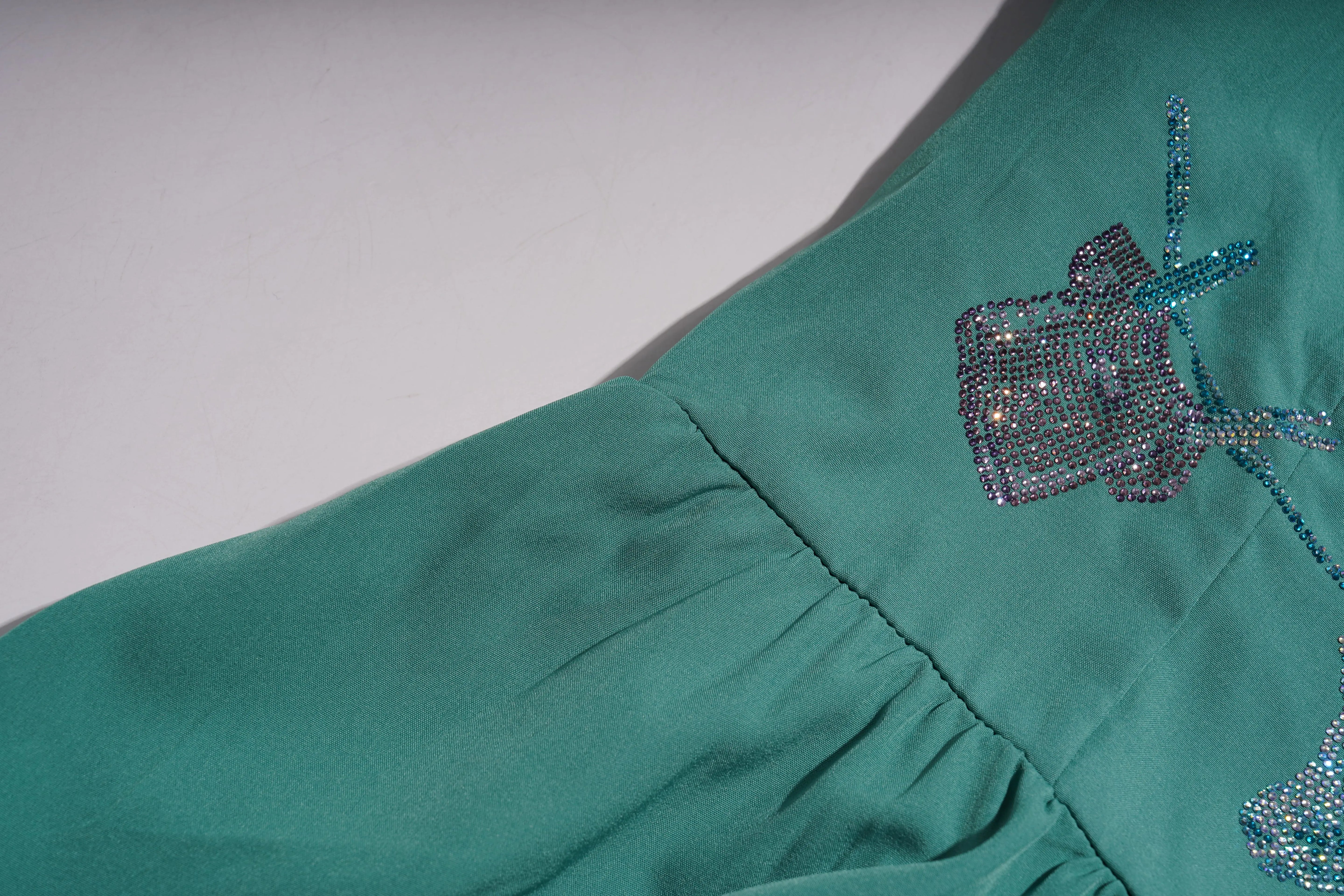 Teal fabric with decorative beadwork on a plain background, TCH Green Rhinestone Teddy Laundry Story Dress