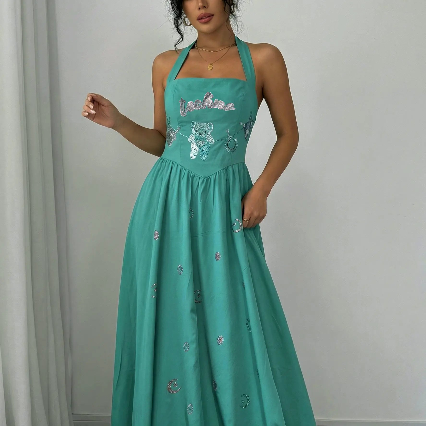 Woman wearing a teal dress with floral embroidery against a plain background, TCH Green Rhinestone Teddy Laundry Story Dress