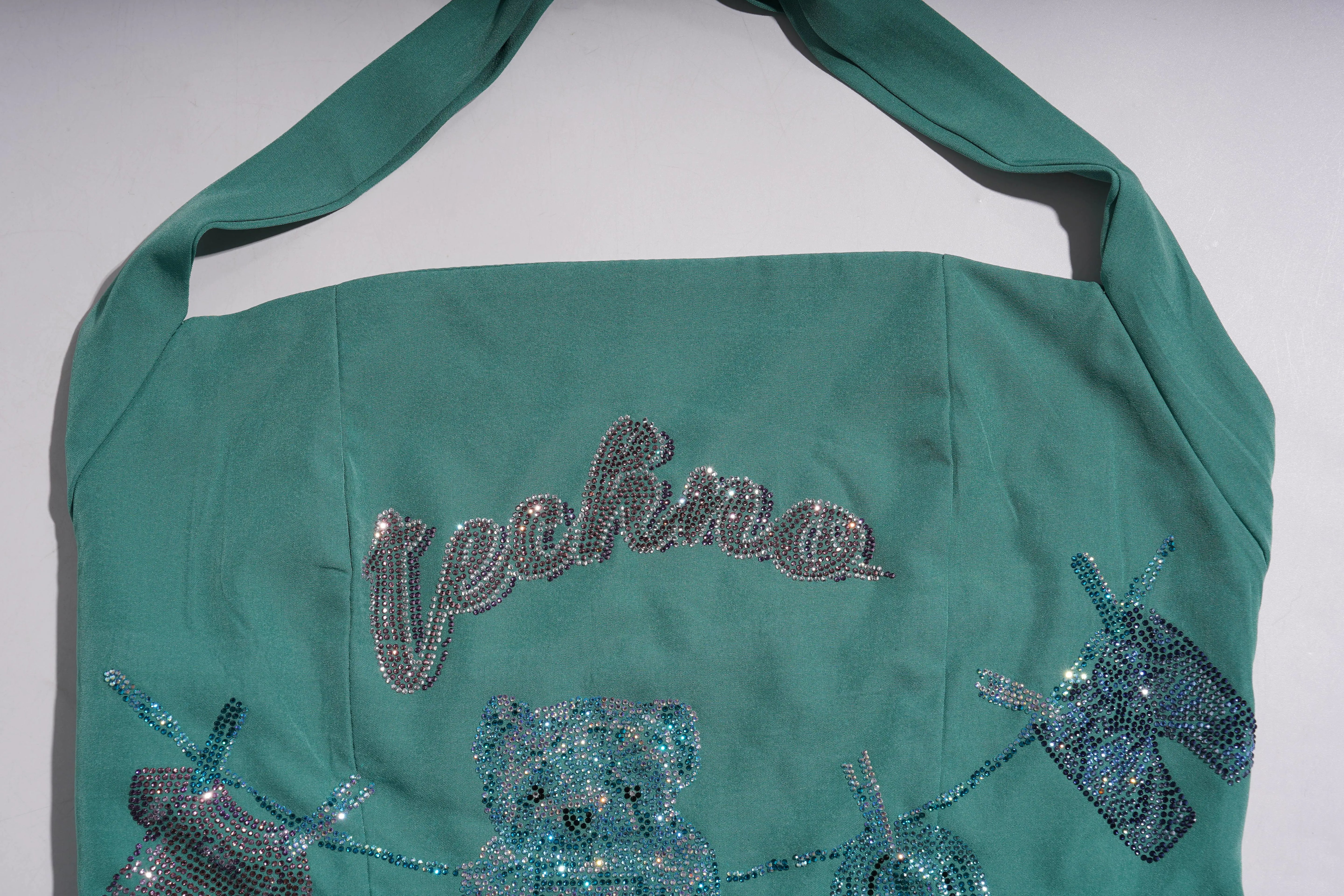 Teal bag with 'techno' text and sequin designs on a white background, TCH Green Rhinestone Teddy Laundry Story Dress