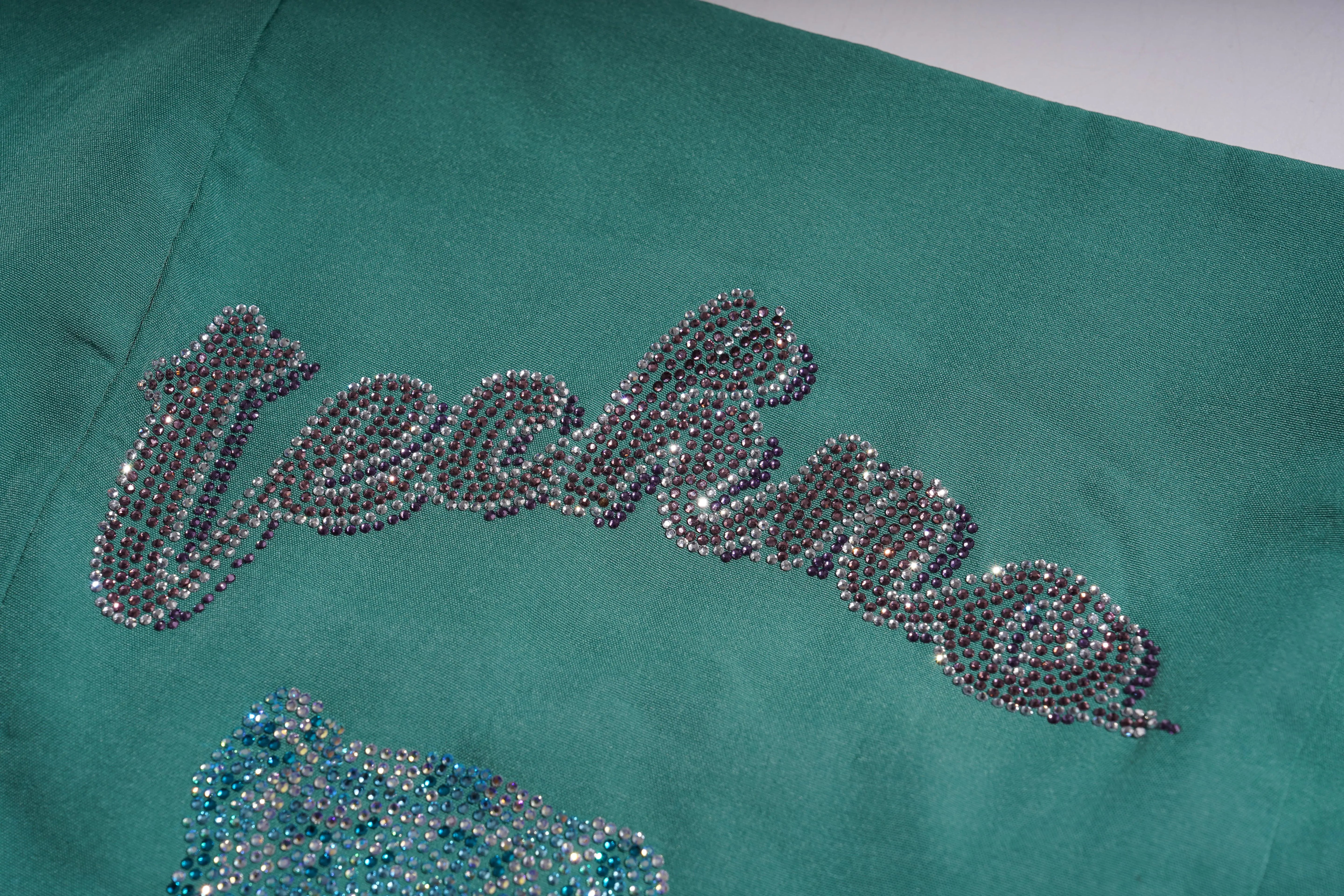Teal jacket with 'techno' text in rhinestones on a plain background, TCH Green Rhinestone Teddy Laundry Story Dress