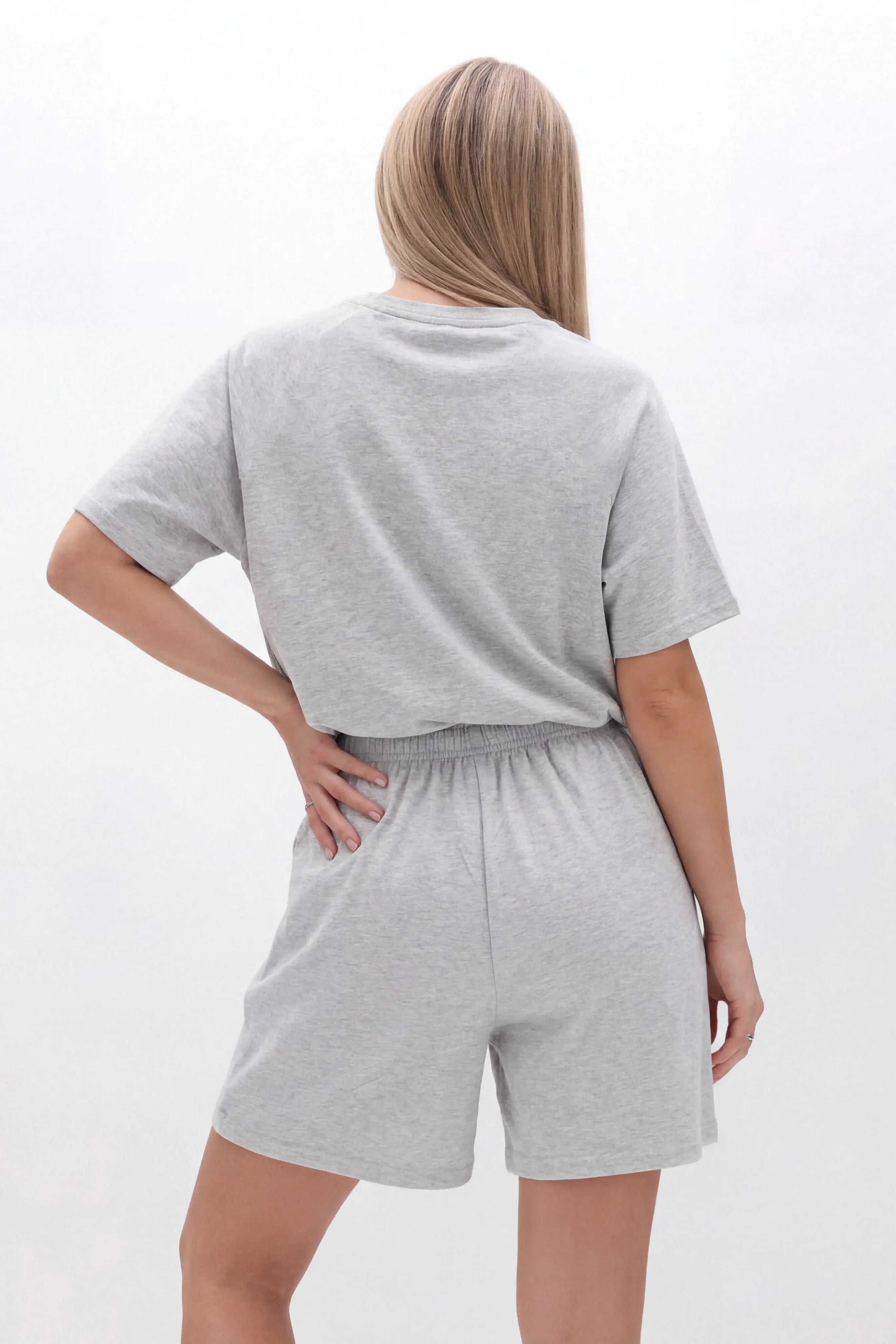 Person wearing a gray oversized t-shirt and shorts set on a white background, TCH Grey Rhinestone Butterfly Pajama Set