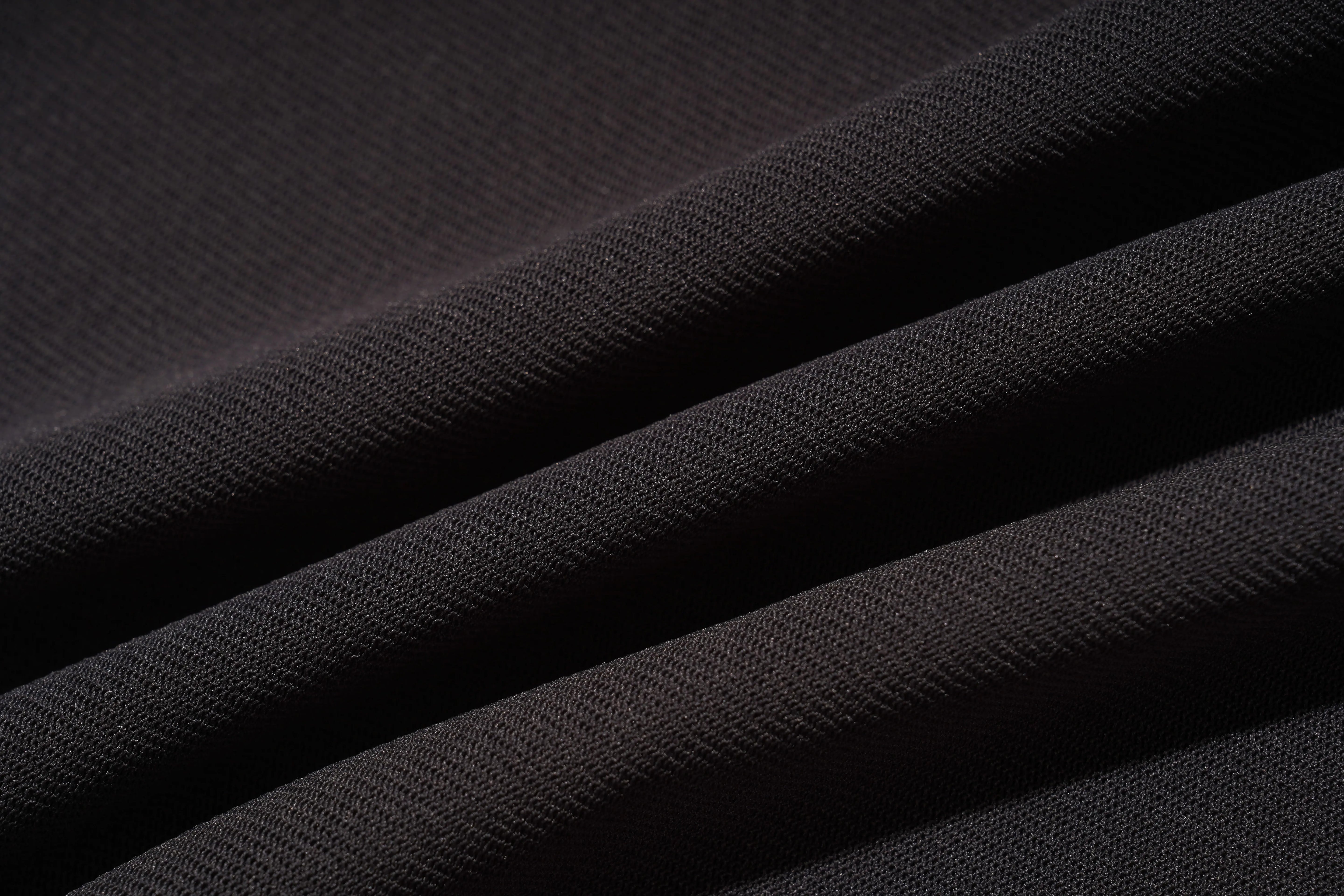 Close-up of black fabric with a textured pattern, TCH Grey Rhinestone Pink Wings Graphic T-Shirt
